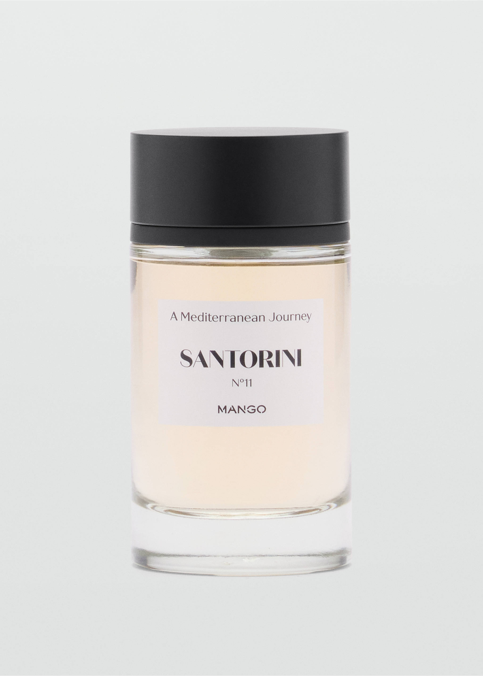 Cylindrical glass perfume bottle with a black cap and Santorini label., Mink Grey. Ref: 47001443-00.