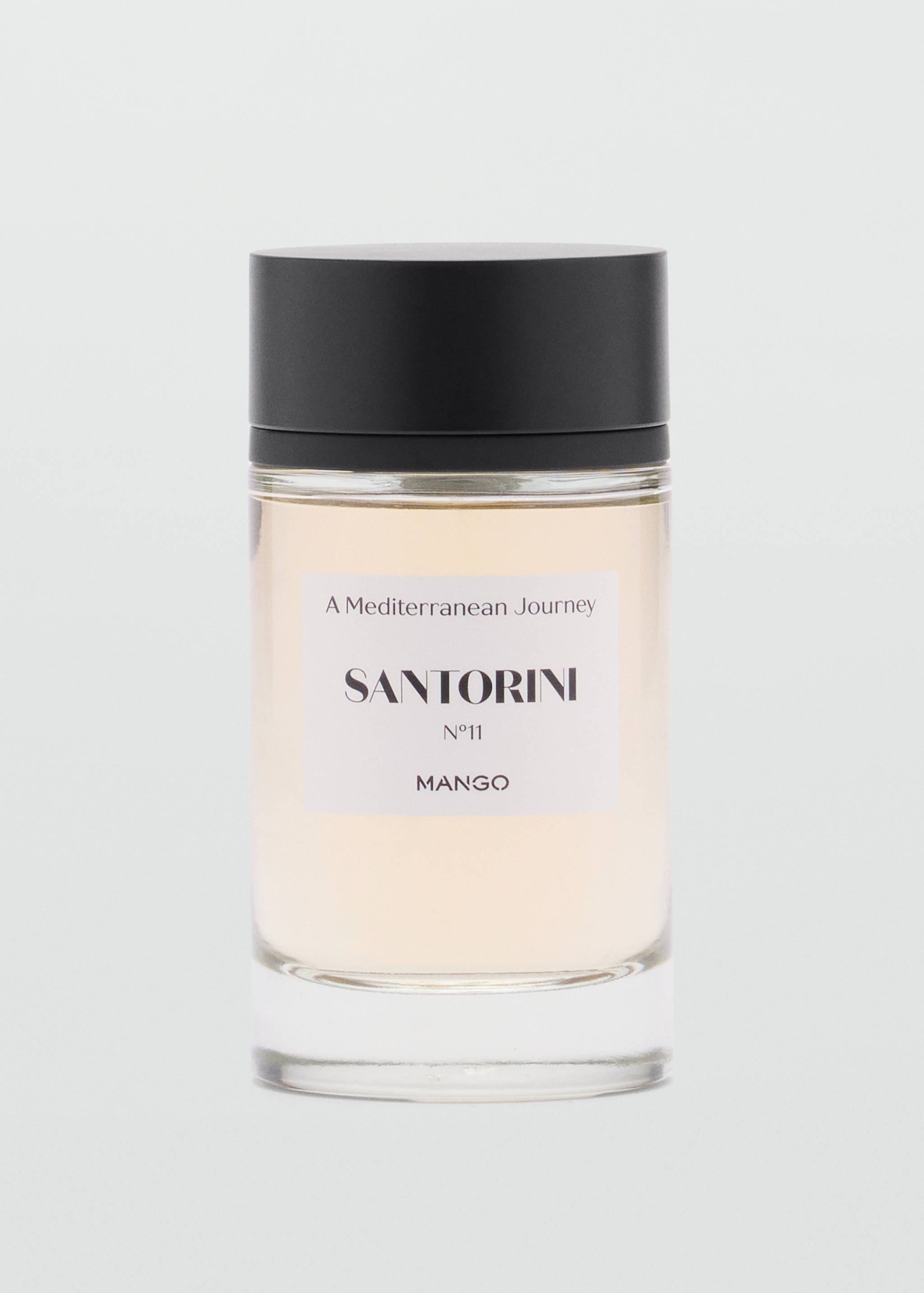 Cylindrical glass perfume bottle with a black cap and Santorini label.