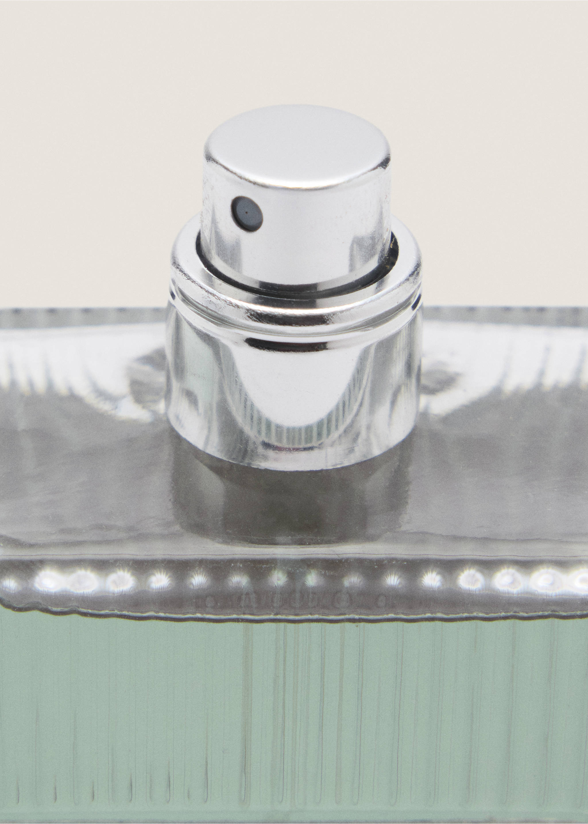 Close-up of a men's perfume bottle showing the silver spray nozzle., Mink Grey. Ref: 47001452-00.