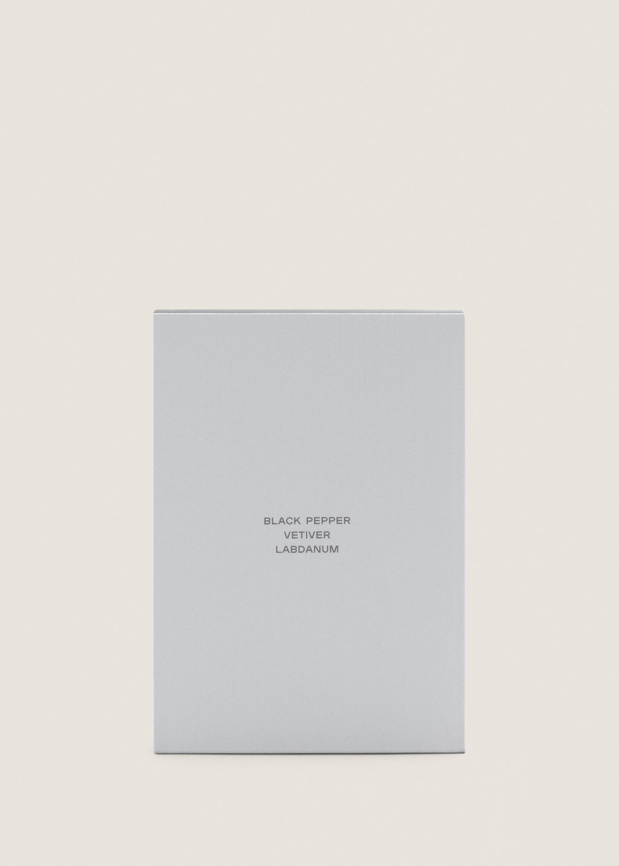Close-up of a grey perfume box featuring black text.