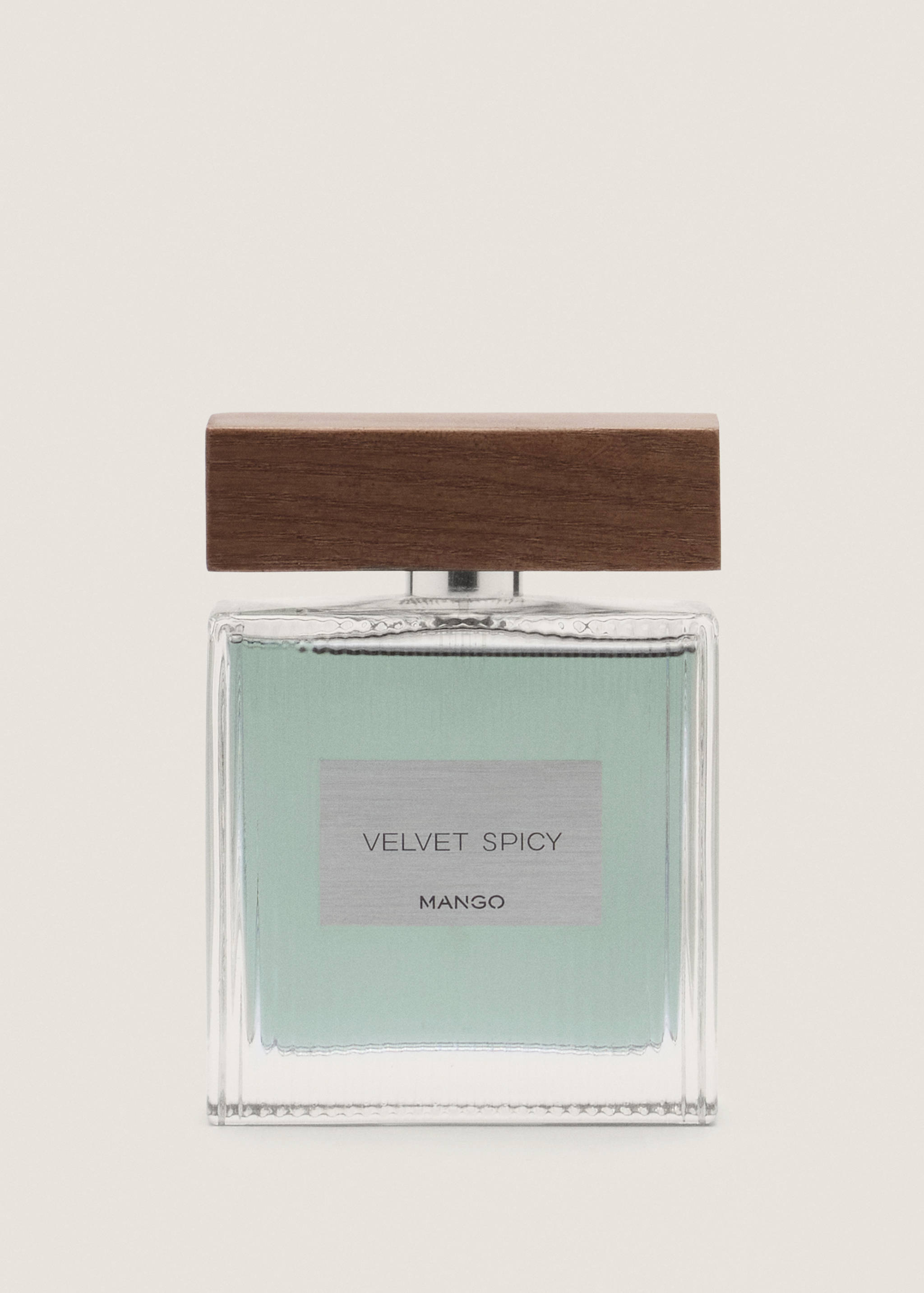 Perfume bottle in pale green with a wooden cap and Mango label.