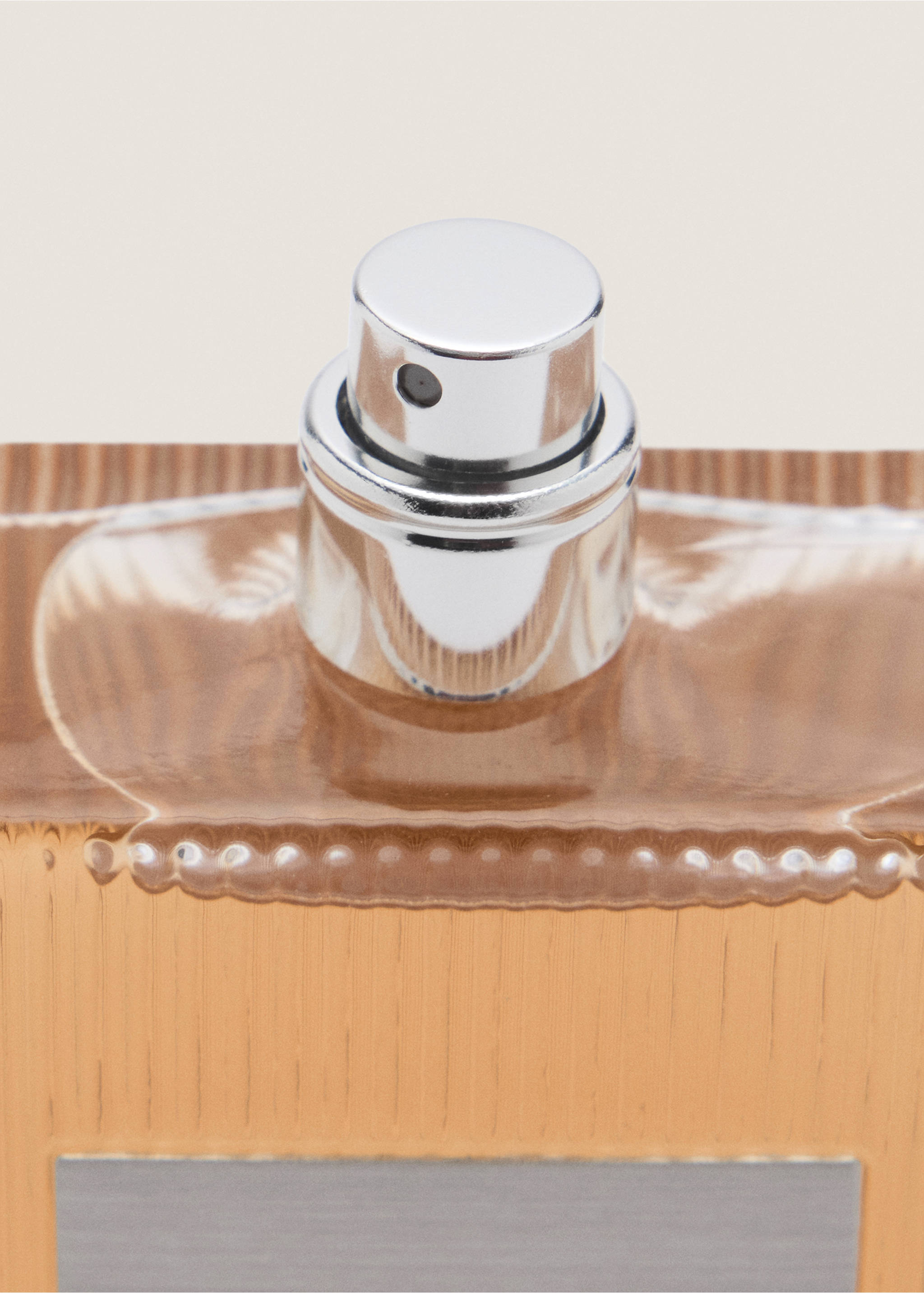 Close-up of a perfume bottle with a wood-grain pattern and a silver spray nozzle., Mink Grey. Ref: 47001453-00.