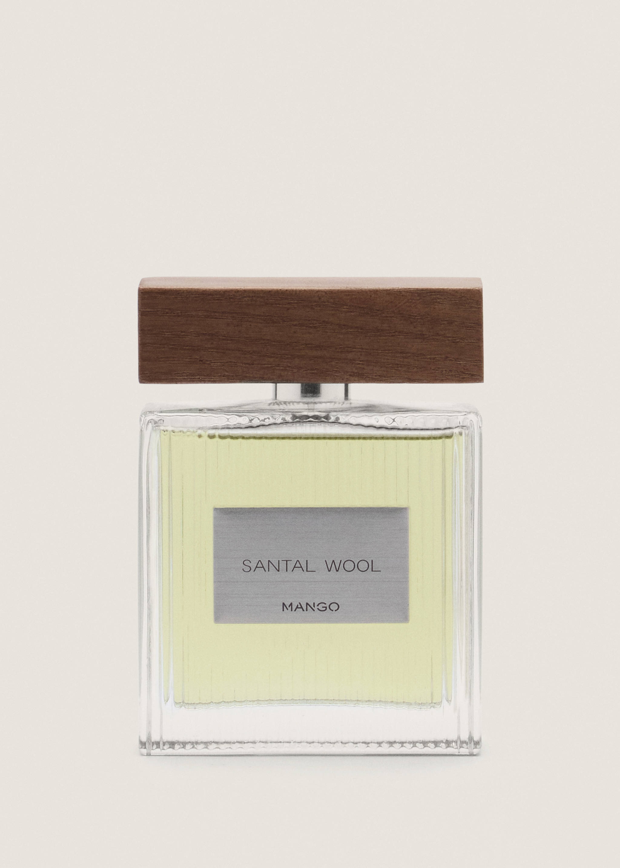 Perfume bottle with light-yellow liquid and a thick wooden cap.