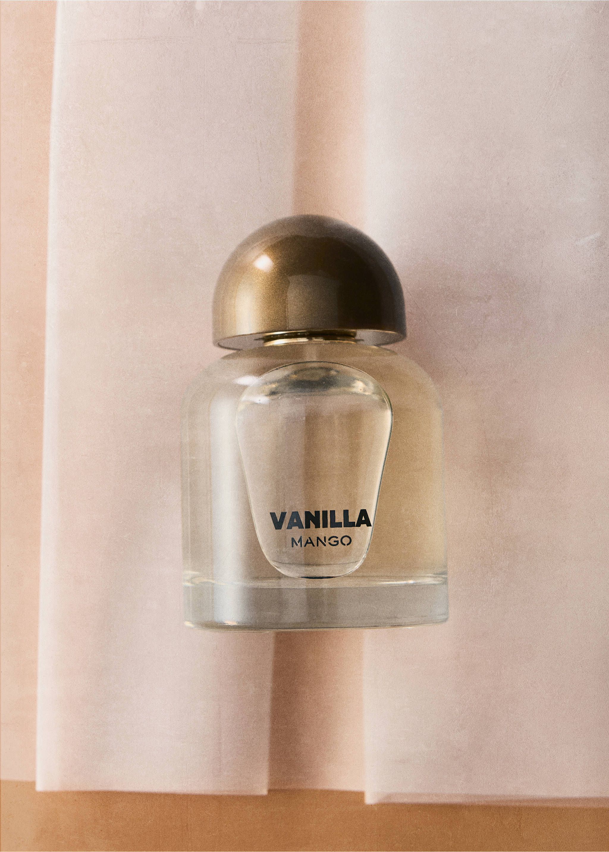 Vanilla Mango perfume bottle with a rounded bronze-coloured cap., Mink Grey. Ref: 47001455-00.