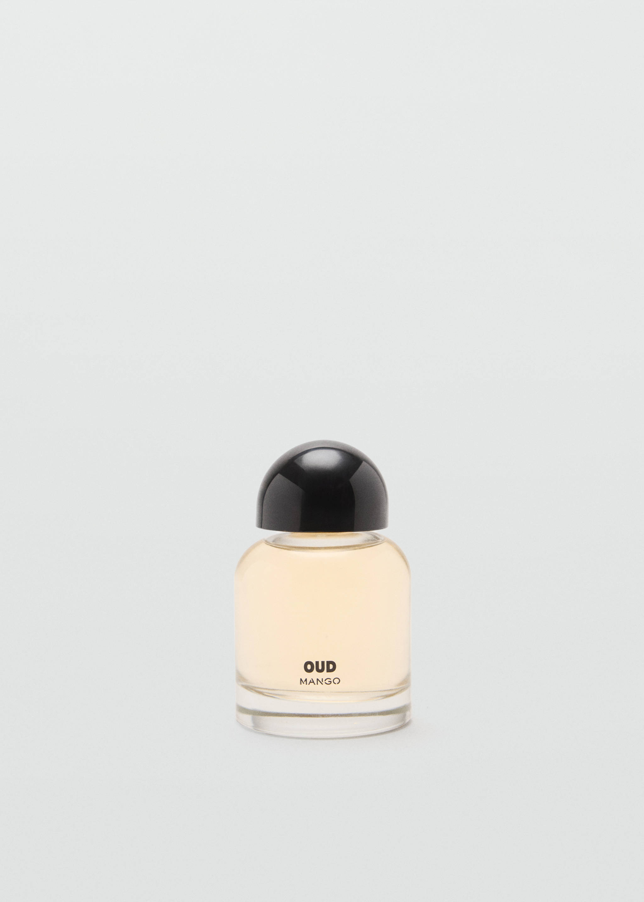 Glass perfume bottle filled with amber fragrance, featuring a black cap and text on the front.