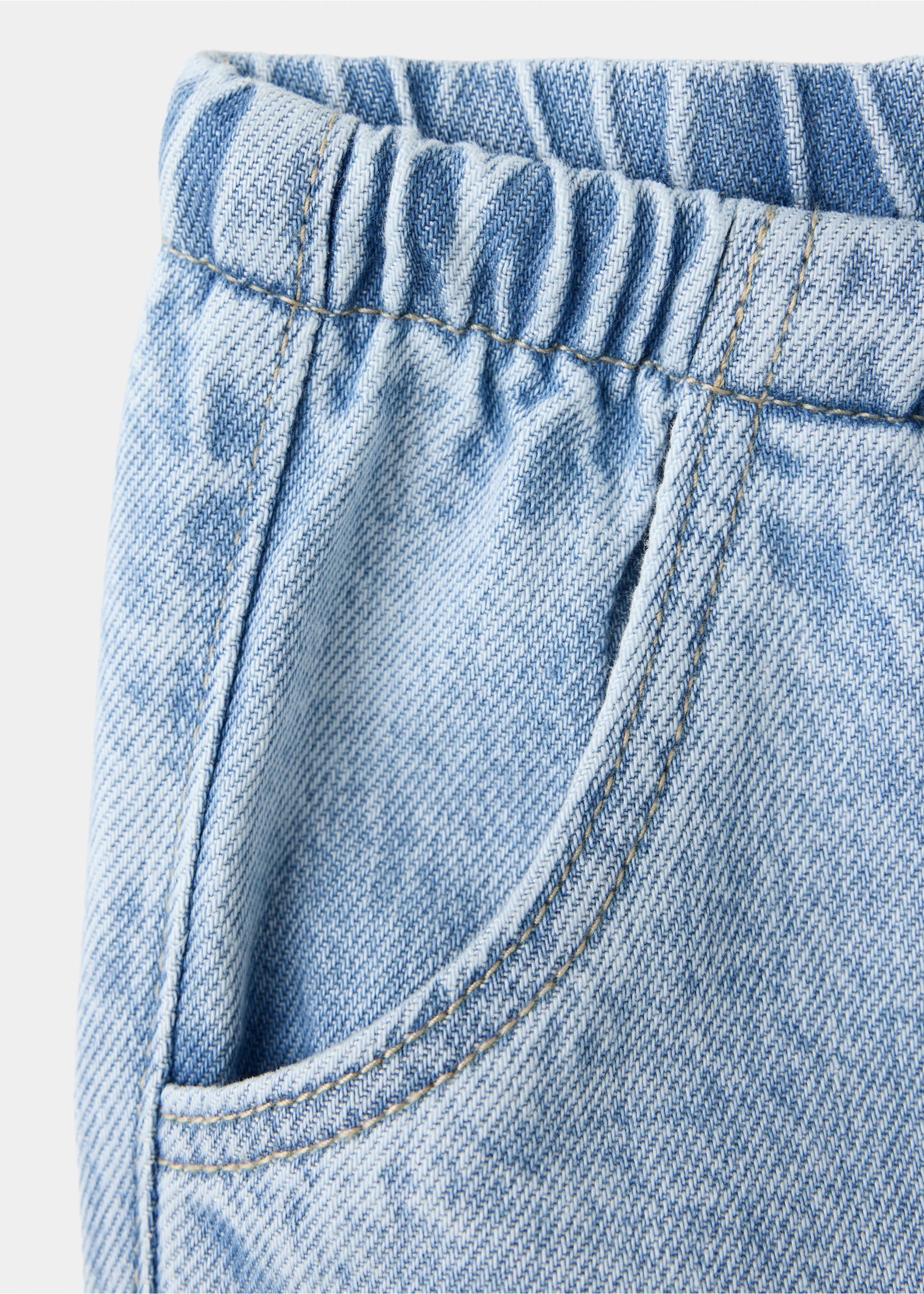 Close-up of light blue denim trousers showing the elasticated waistband and pocket., Medium Blue. Ref: 47011335-00.