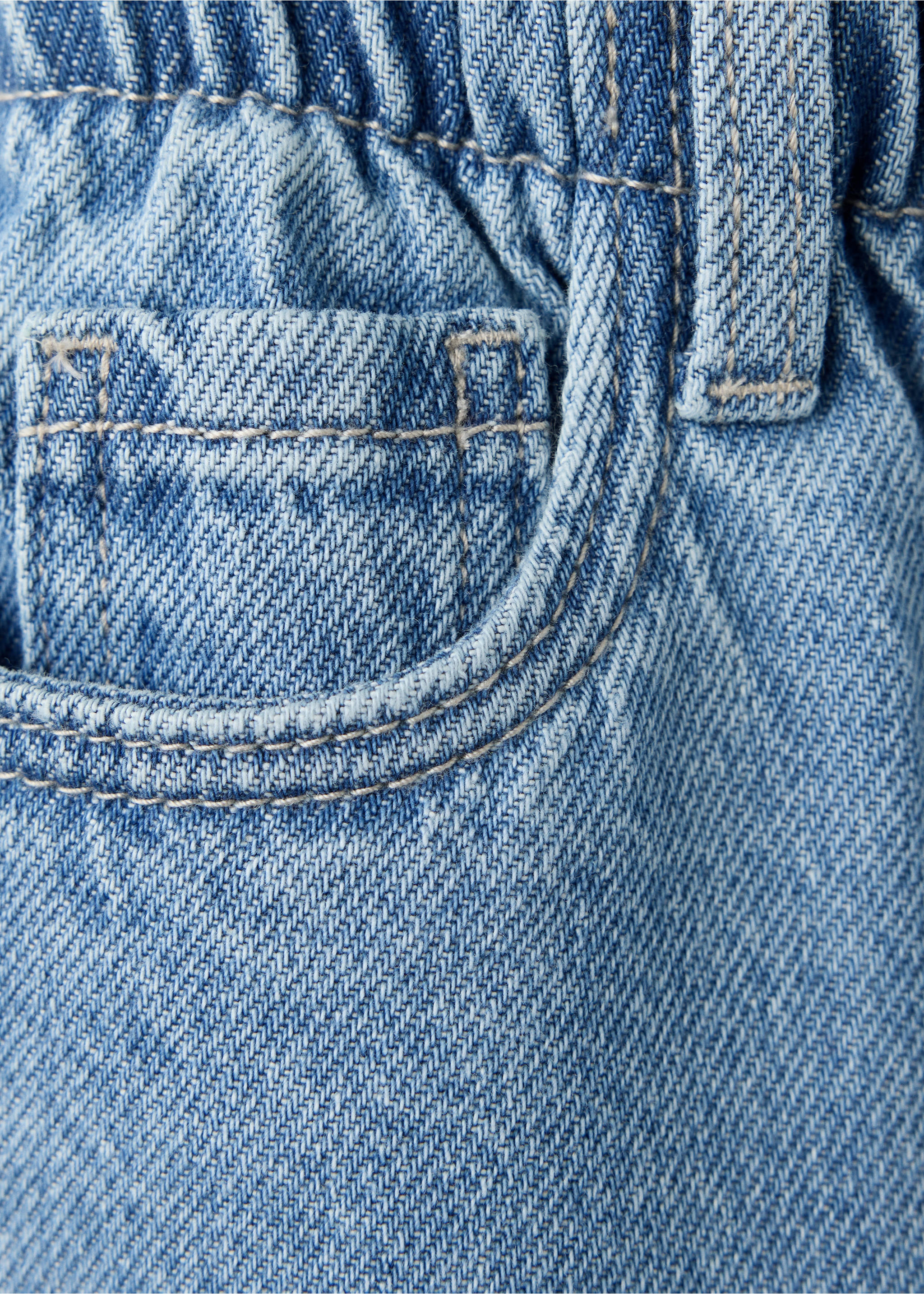 Close-up of light blue denim trousers with an elastic waistband and coin pocket., Medium Blue. Ref: 47011337-00.