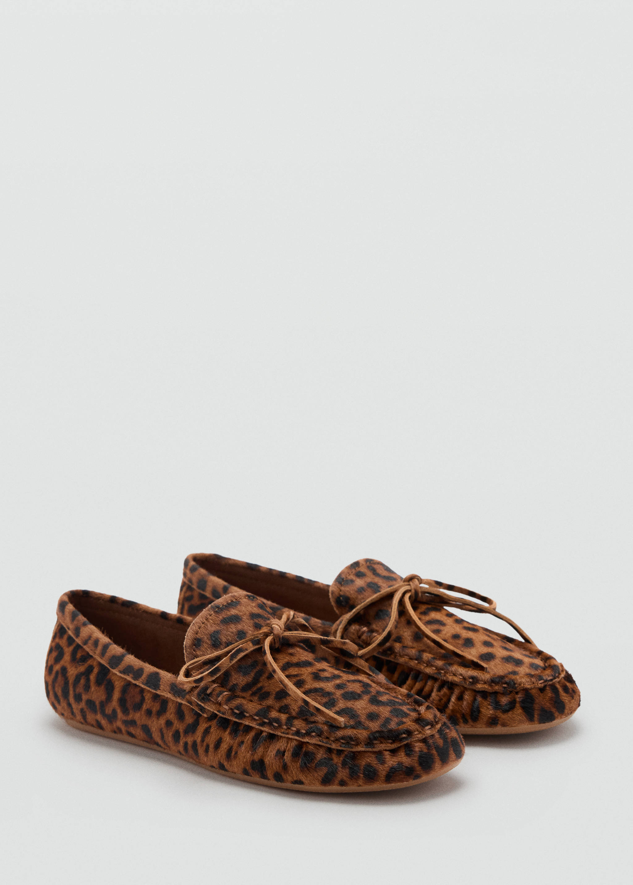 Leopard print faux-fur moccasins with leather bow ties.