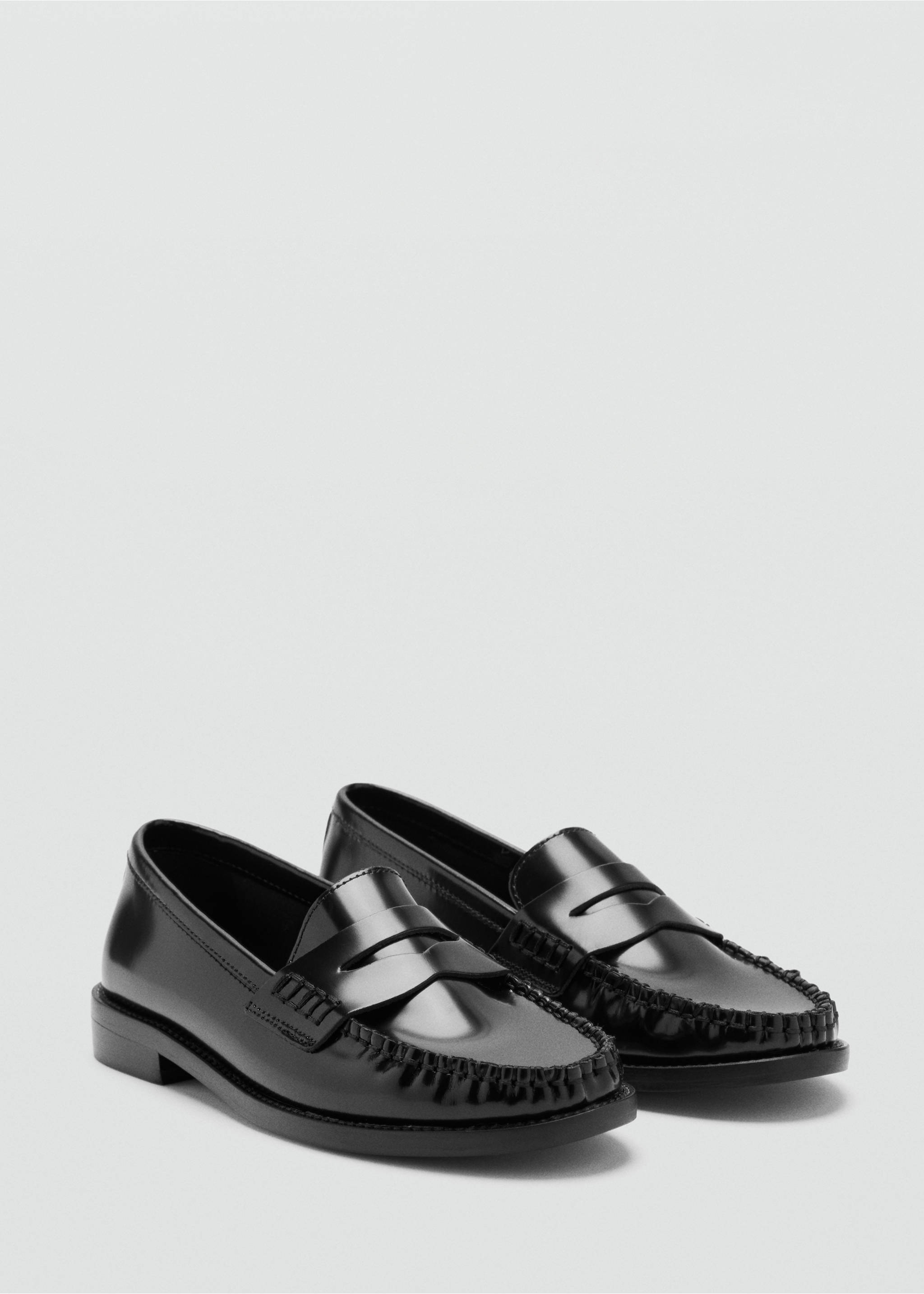 Black patent leather loafers with classic moc-toe stitching and a traditional saddle strap., Black. Ref: 47011348-00.