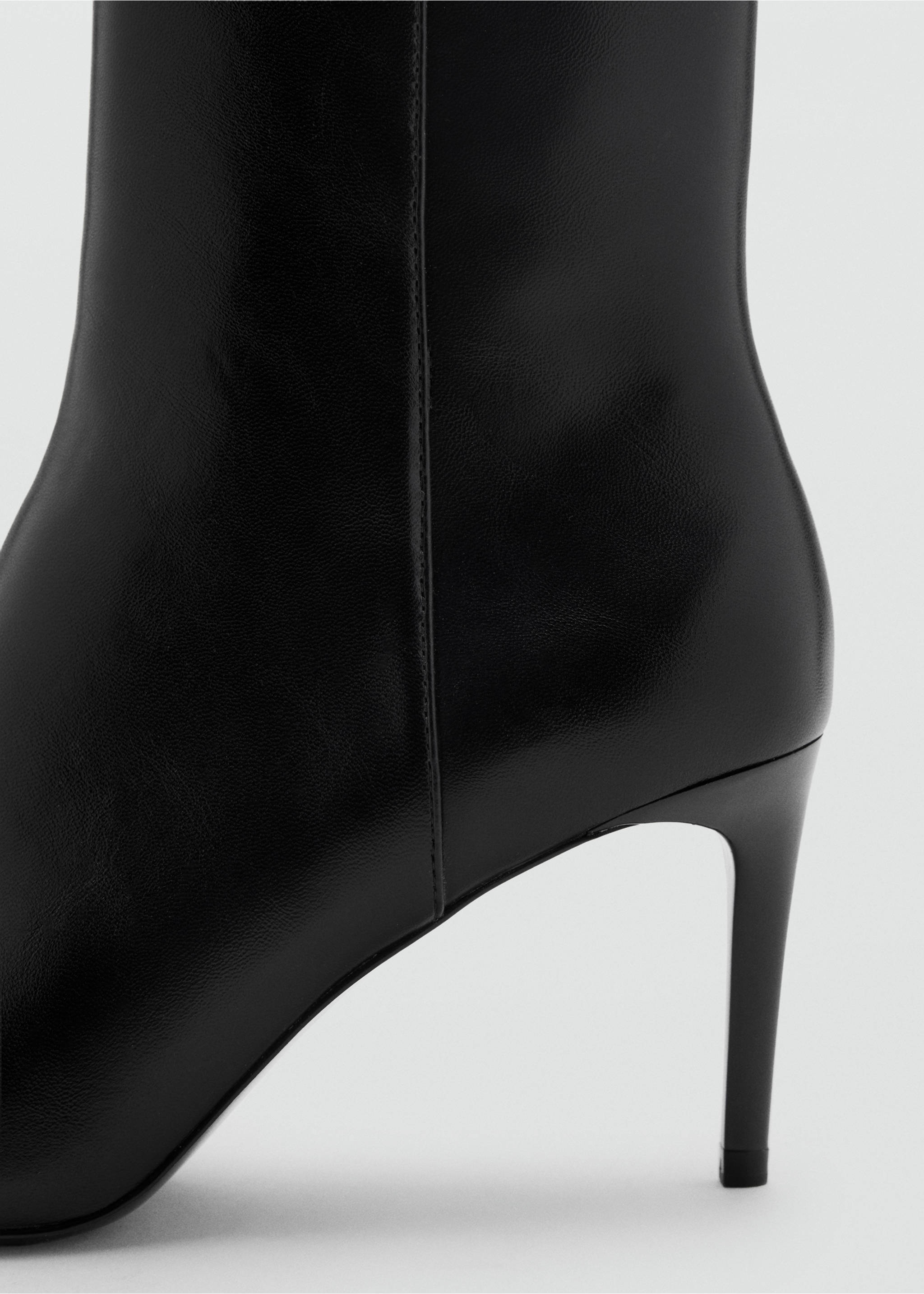 Close-up of a black ankle boot with a slim stiletto heel., Black. Ref: 47011353-00.