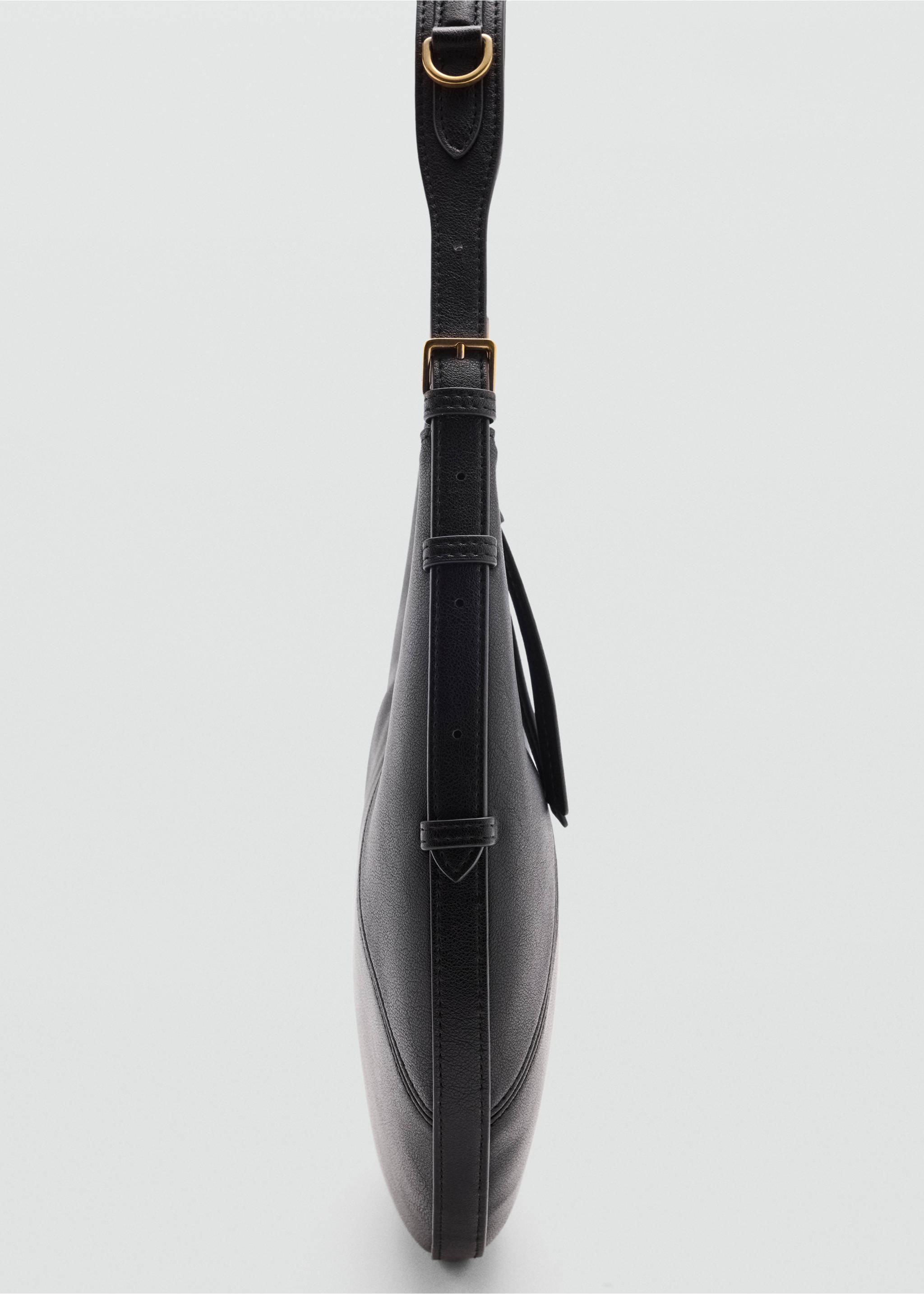 Close-up of a black shoulder bag showing side strap detail and gold-tone hardware., Black. Ref: 47011355-00.