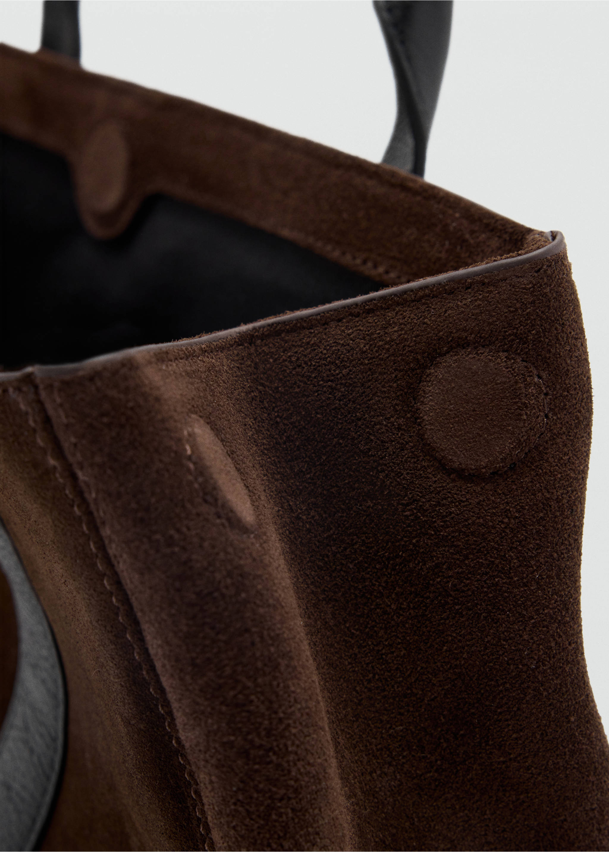 Close-up of a dark brown suede city bag showing texture and topstitching., Chocolate. Ref: 47011356-00.