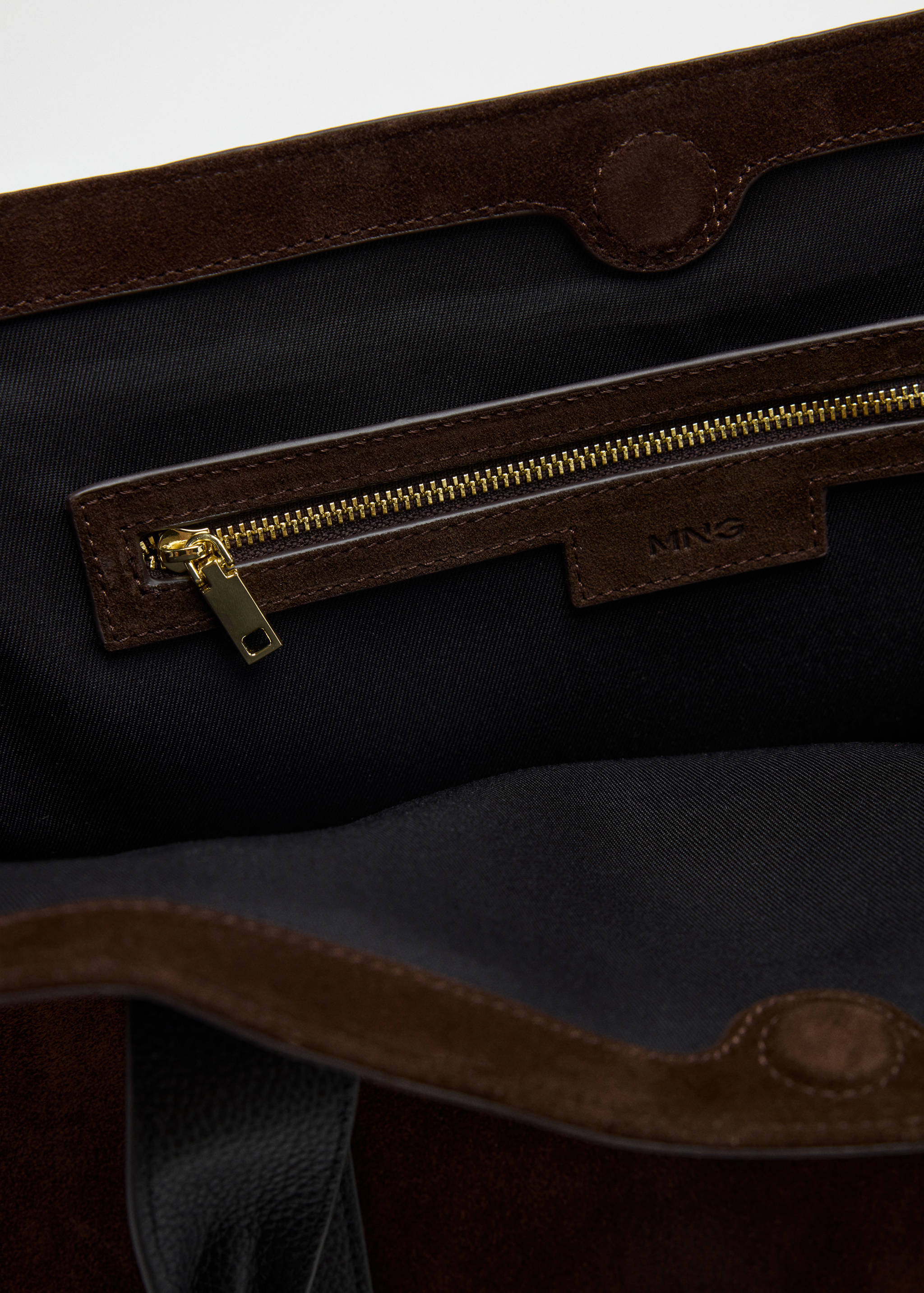 City bag interior detail in dark brown suede with a zip pocket.