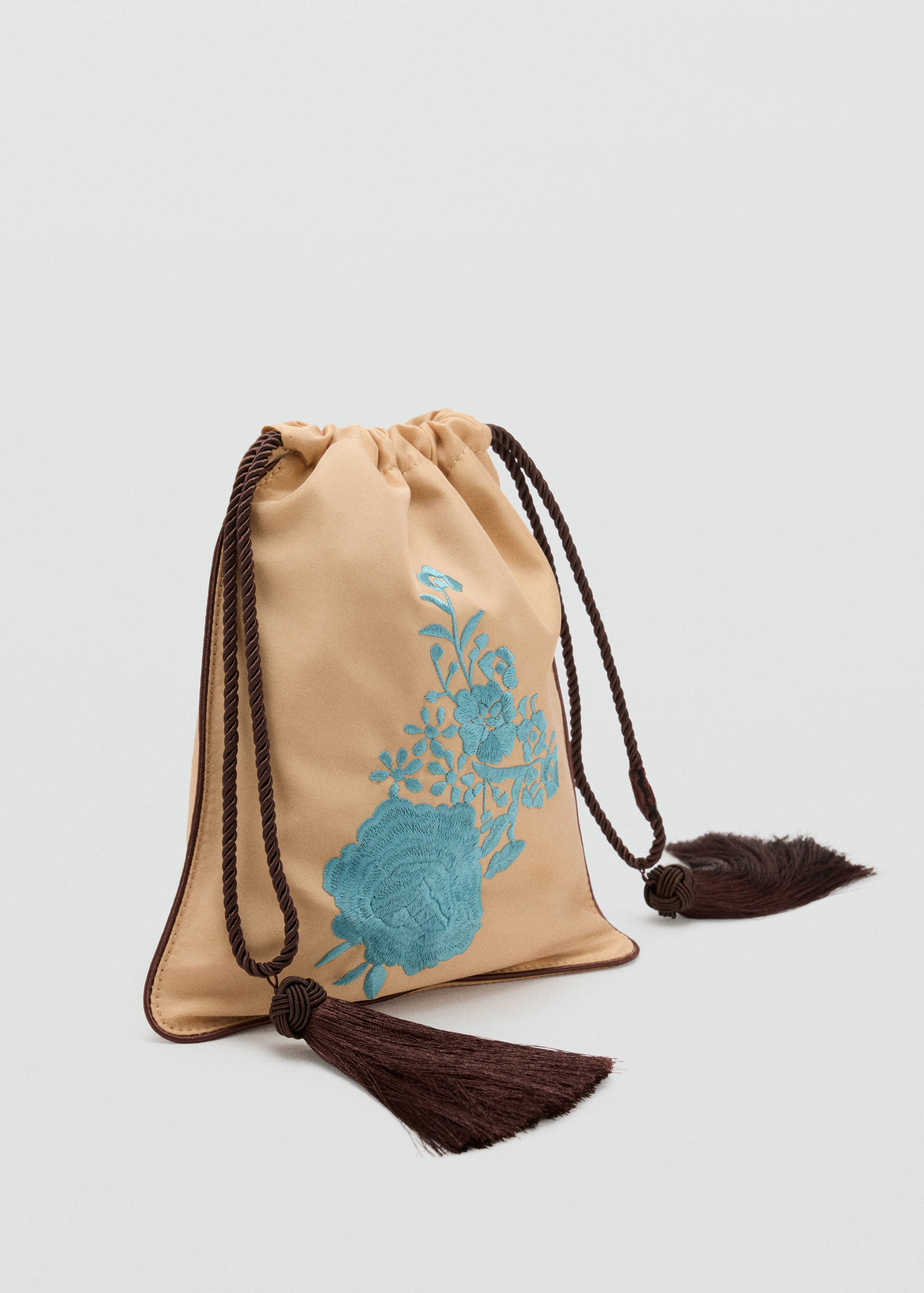 Beige drawstring handbag with turquoise floral embroidery and dark brown tassels.