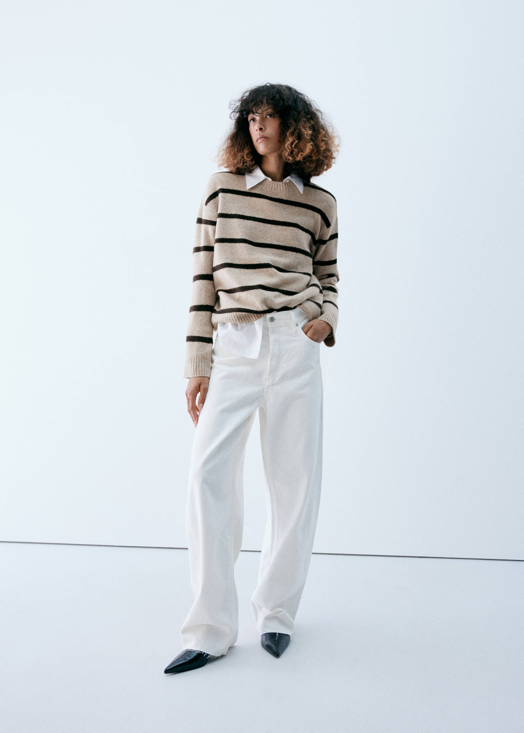 Beige and dark brown striped knit jumper layered over a white shirt.