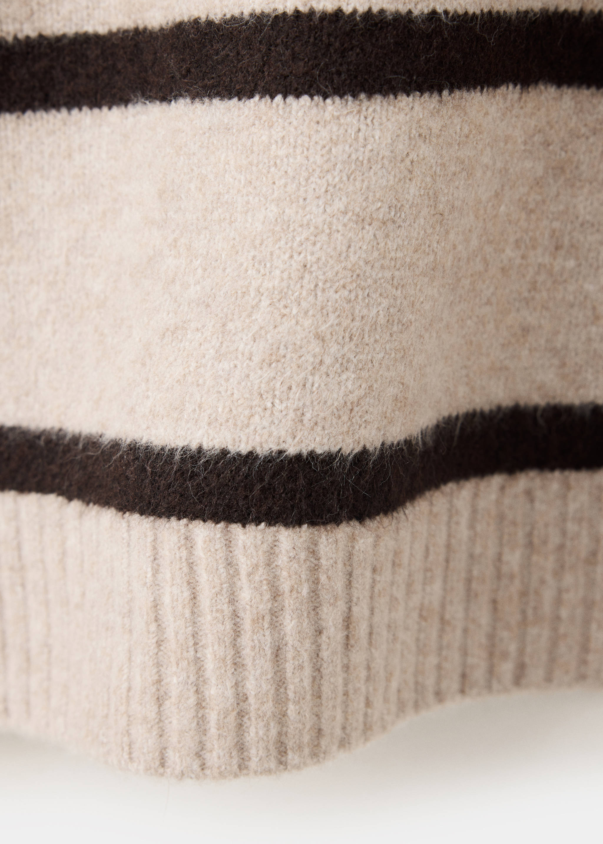 Close-up of a knitted striped jersey fabric texture with a ribbed hem