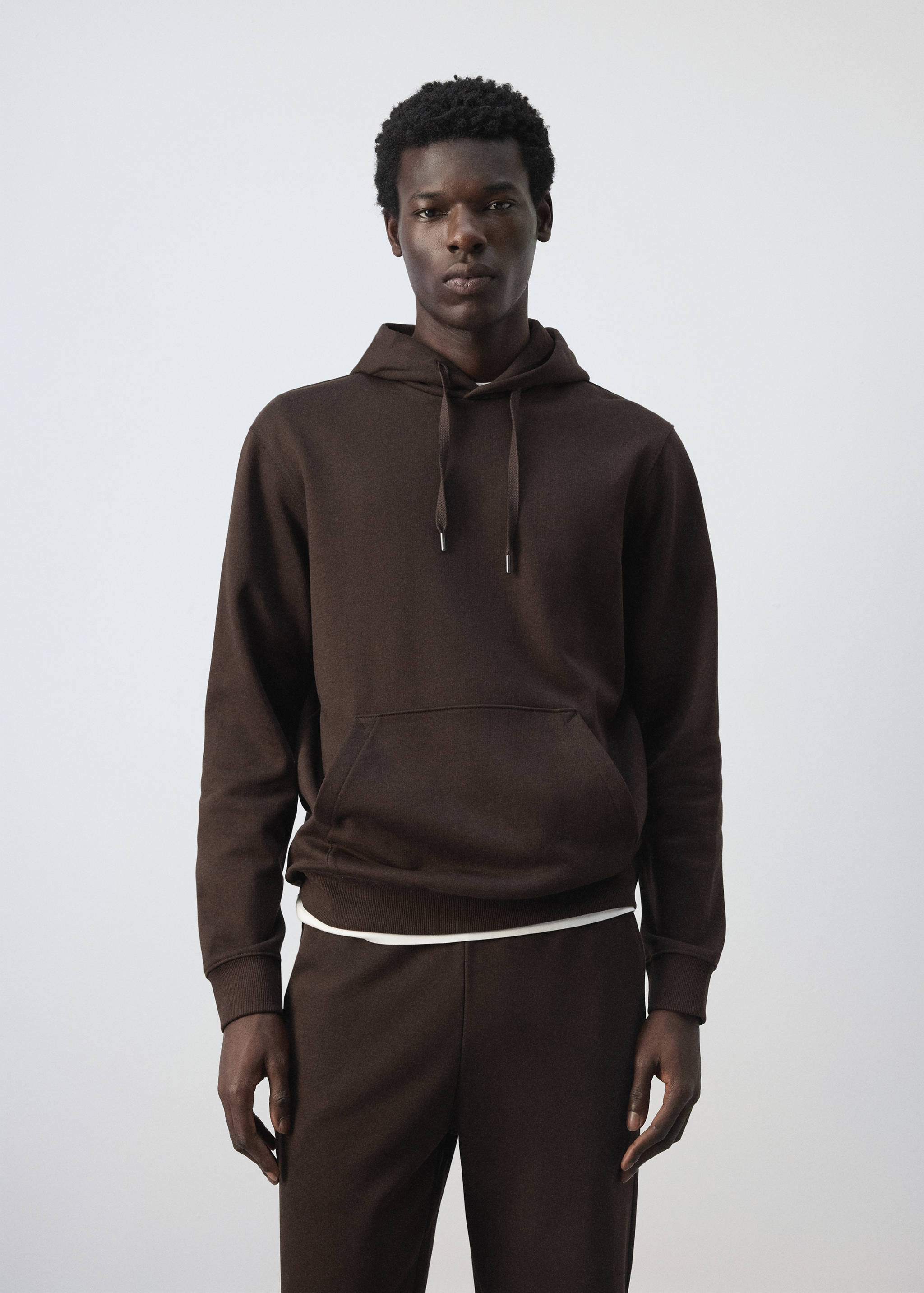 Dark brown hoodie with a drawstring hood and kangaroo pocket.