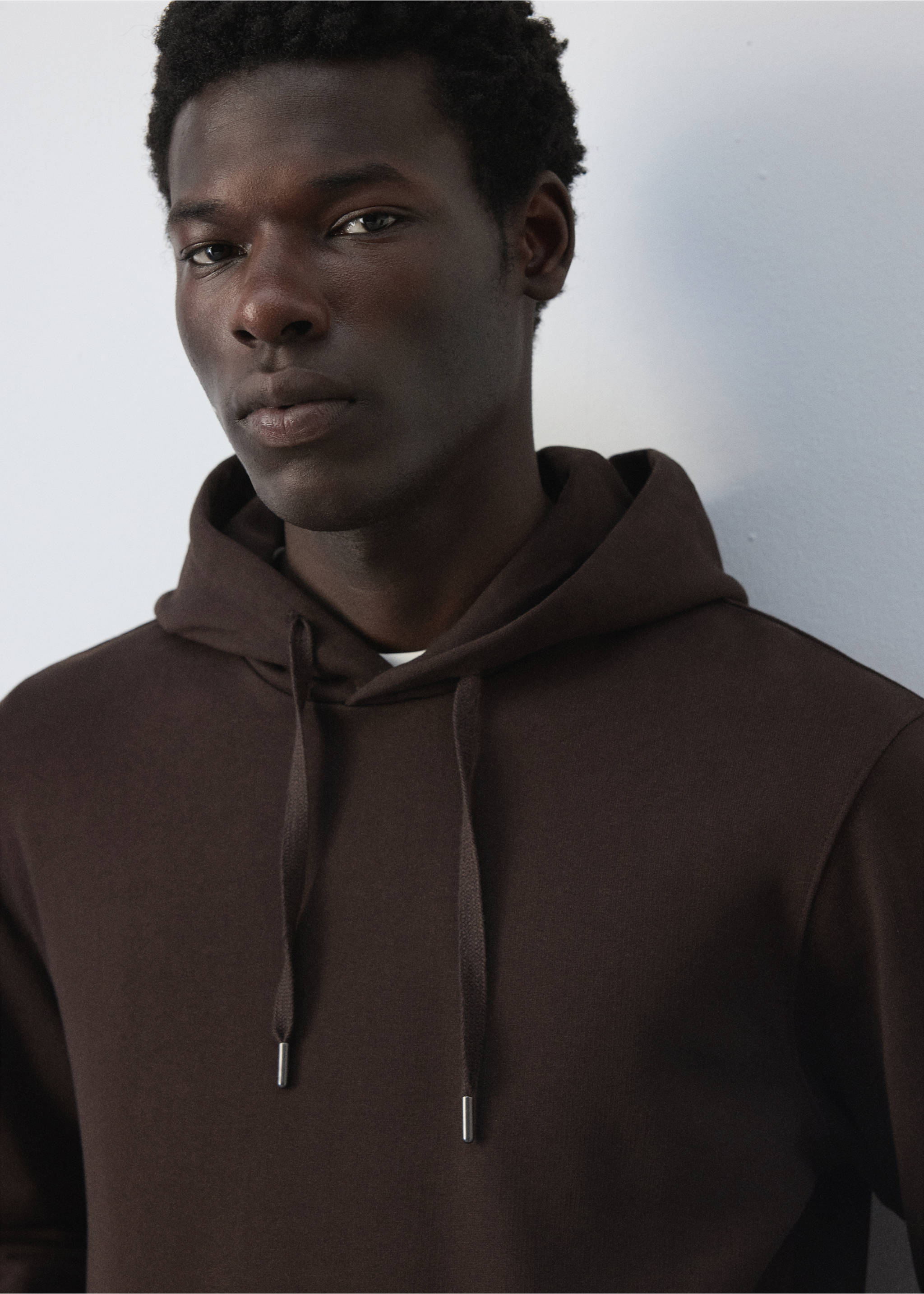 Close-up of a dark brown hoodie with a drawstring hood., Chocolate. Ref: 47011415-00.