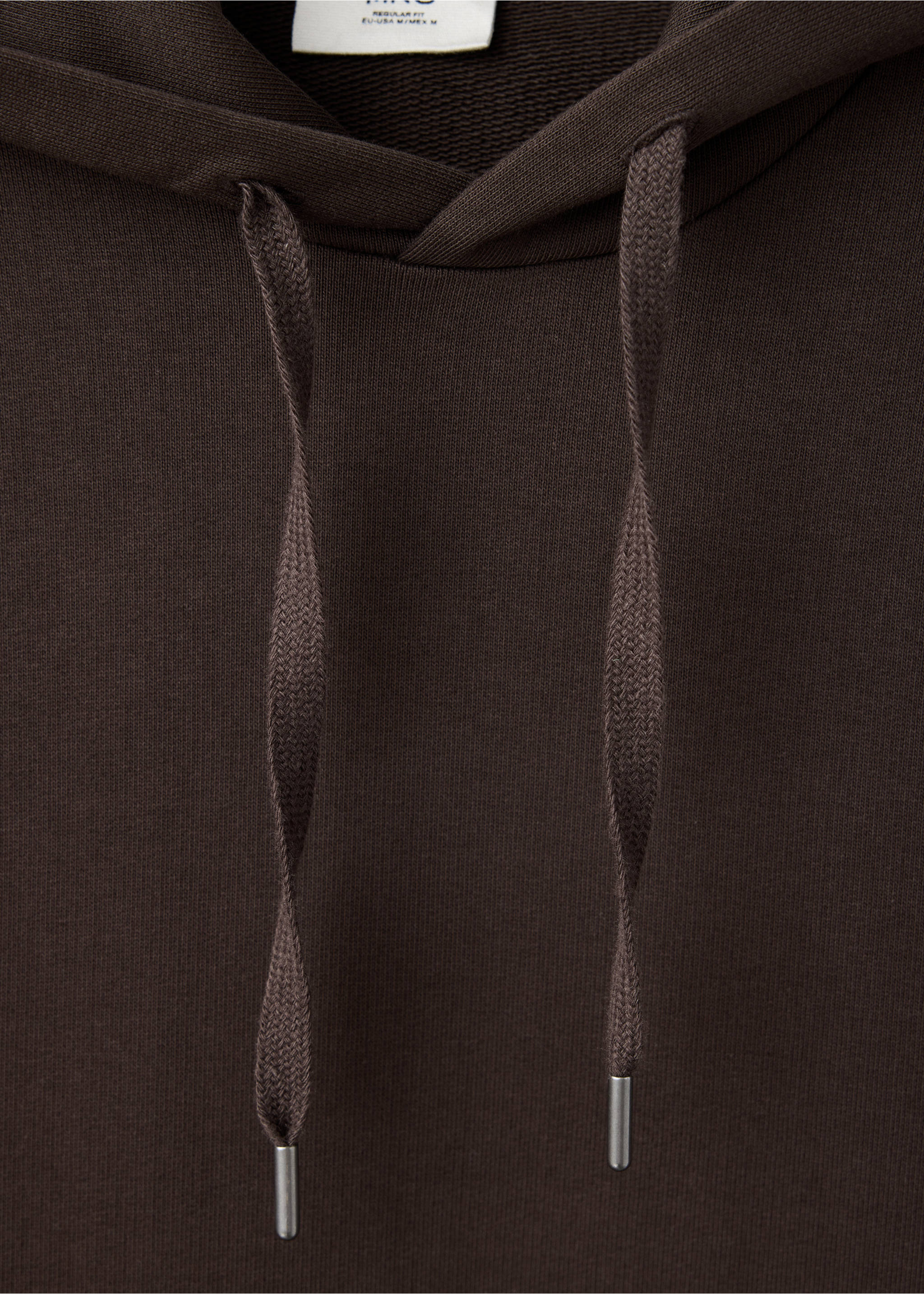 Close-up of a dark brown hoodie with matching drawstrings and silver aglets., Chocolate. Ref: 47011415-00.