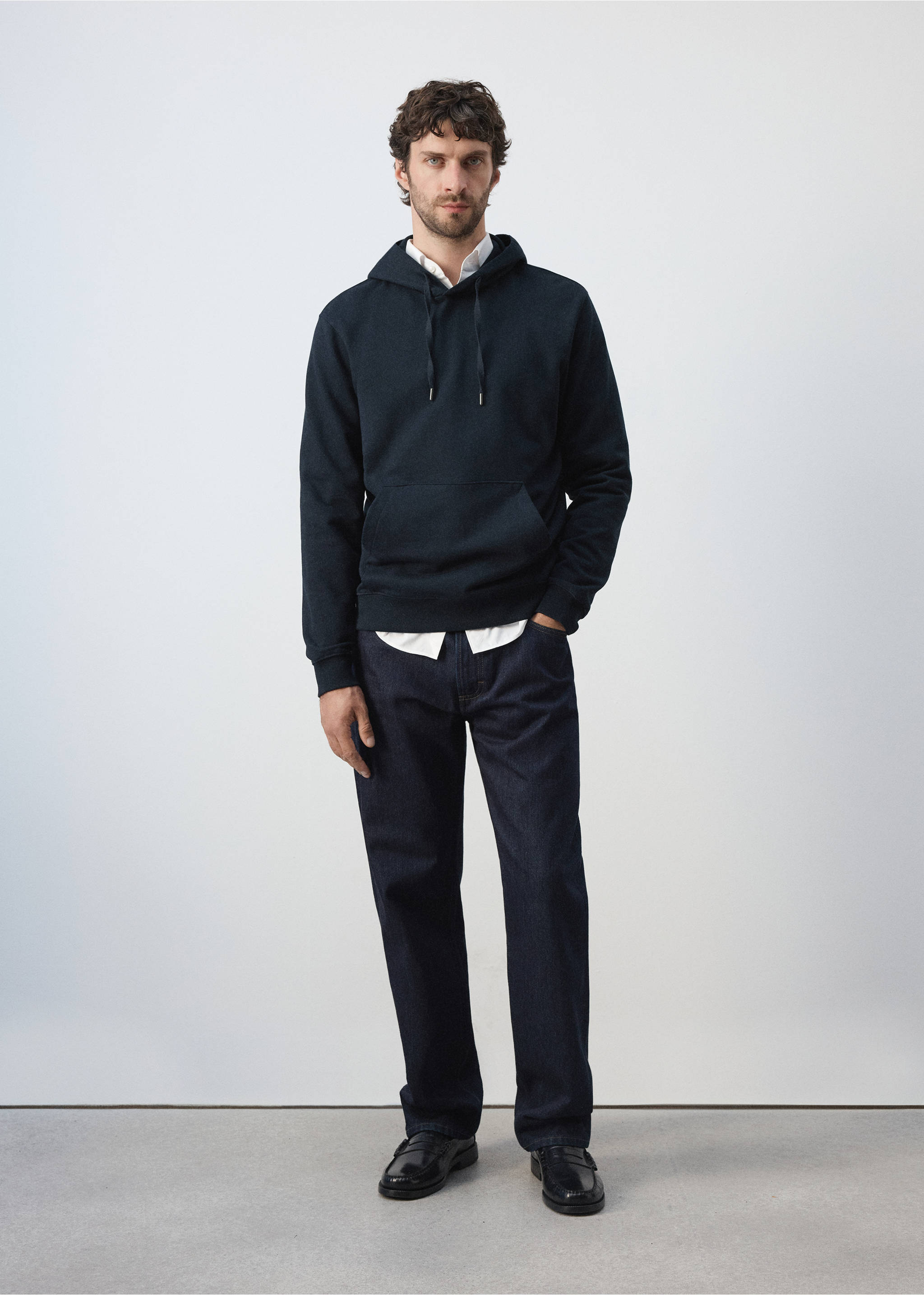 Navy blue hooded sweatshirt with a kangaroo pocket, worn layered over a white shirt., Navy. Ref: 47011415-00.