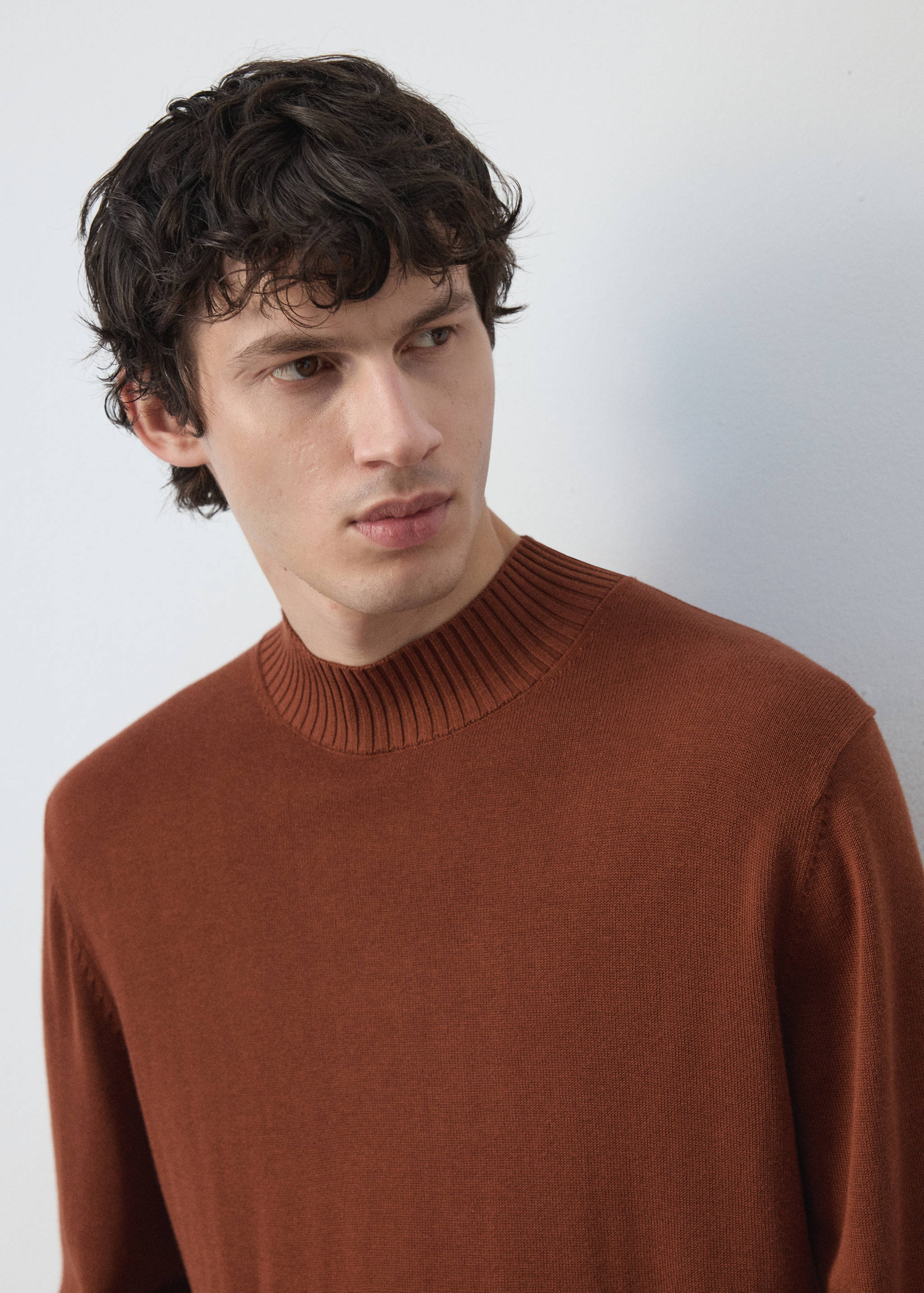 Brown knit jersey with a ribbed mock neckline.