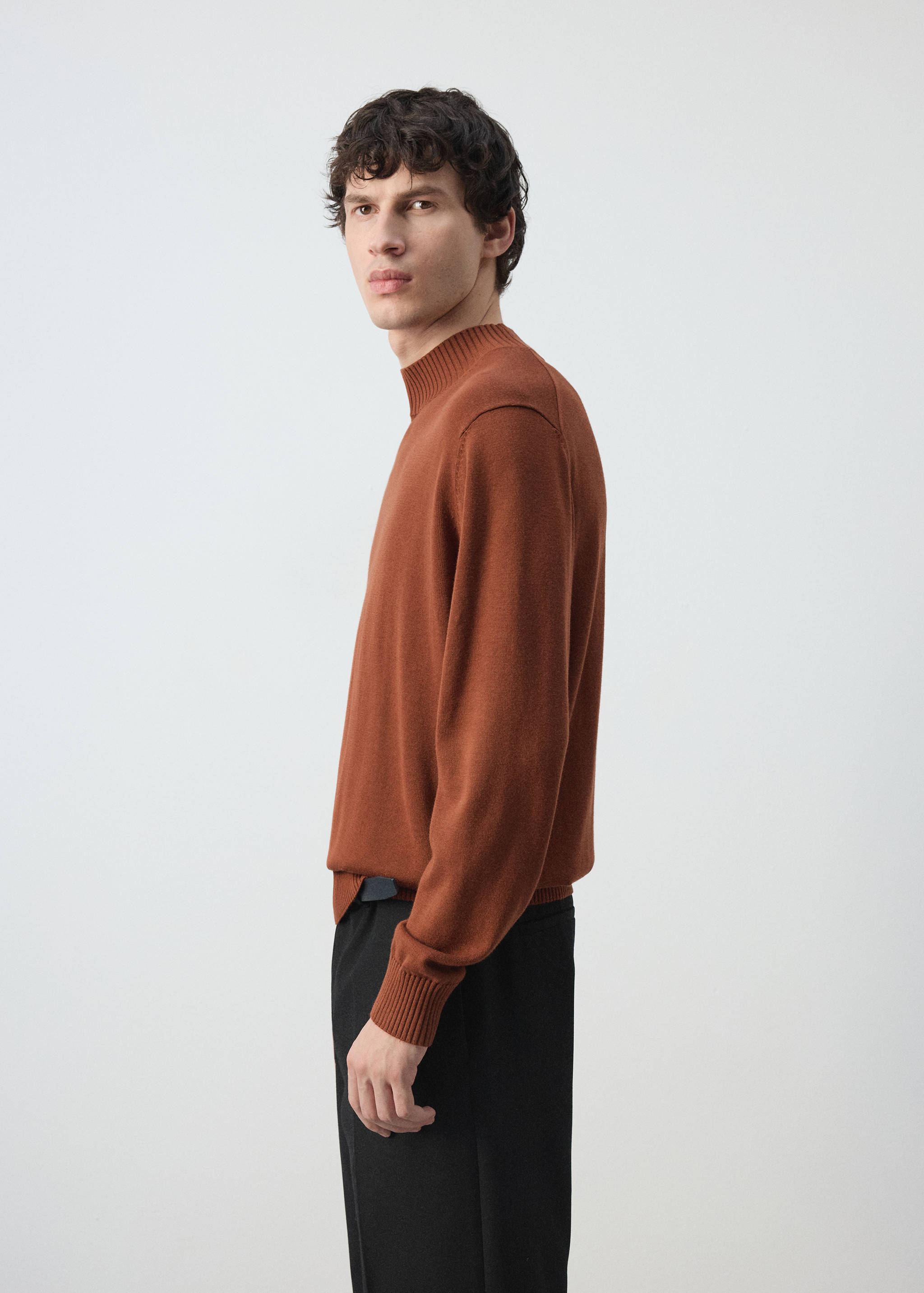 Rust-brown knit jersey with a ribbed high collar and long sleeves.