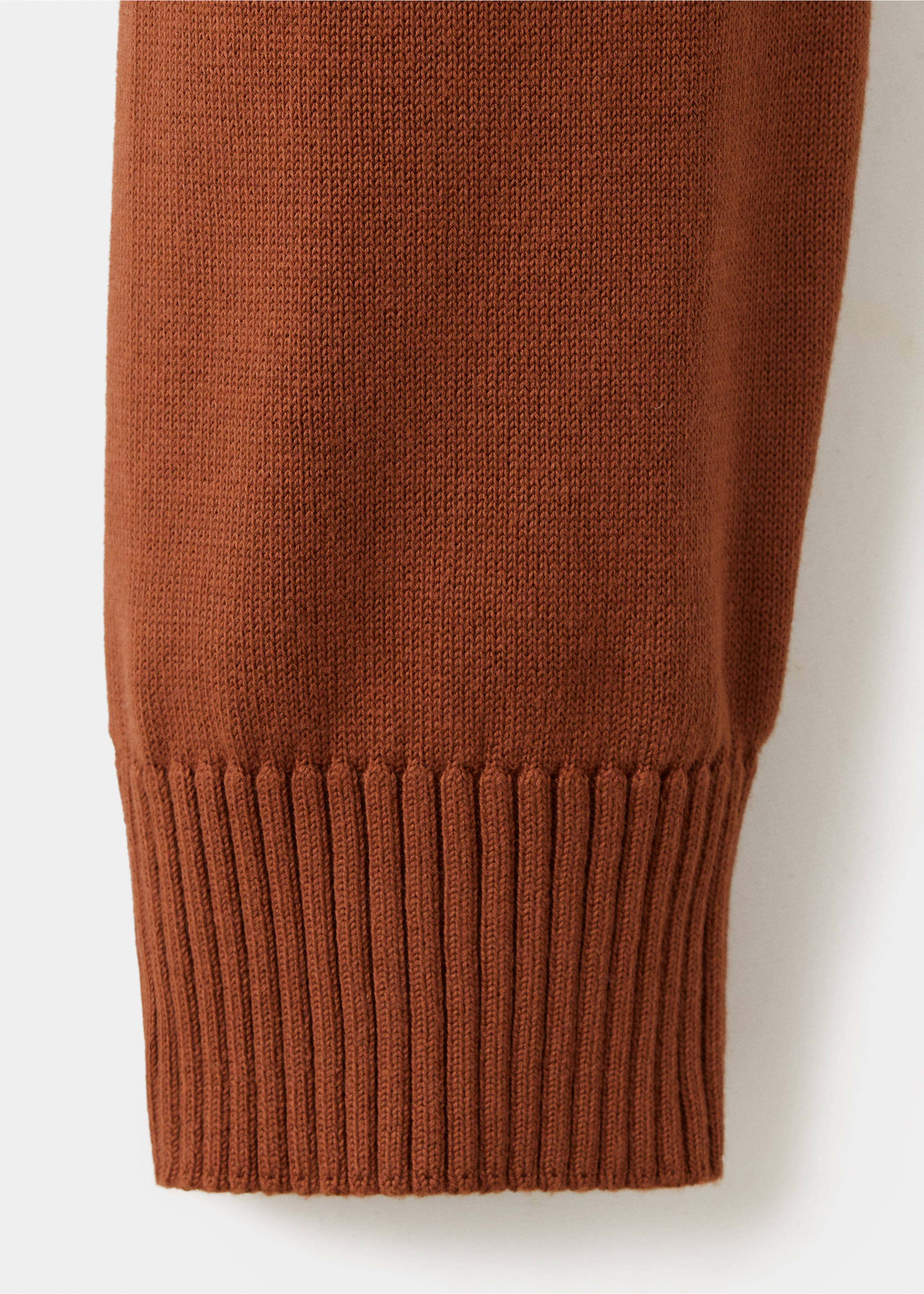 Close-up of a rust-brown men's jumper showing the knit fabric and ribbed cuff., Russet. Ref: 47021335-00.