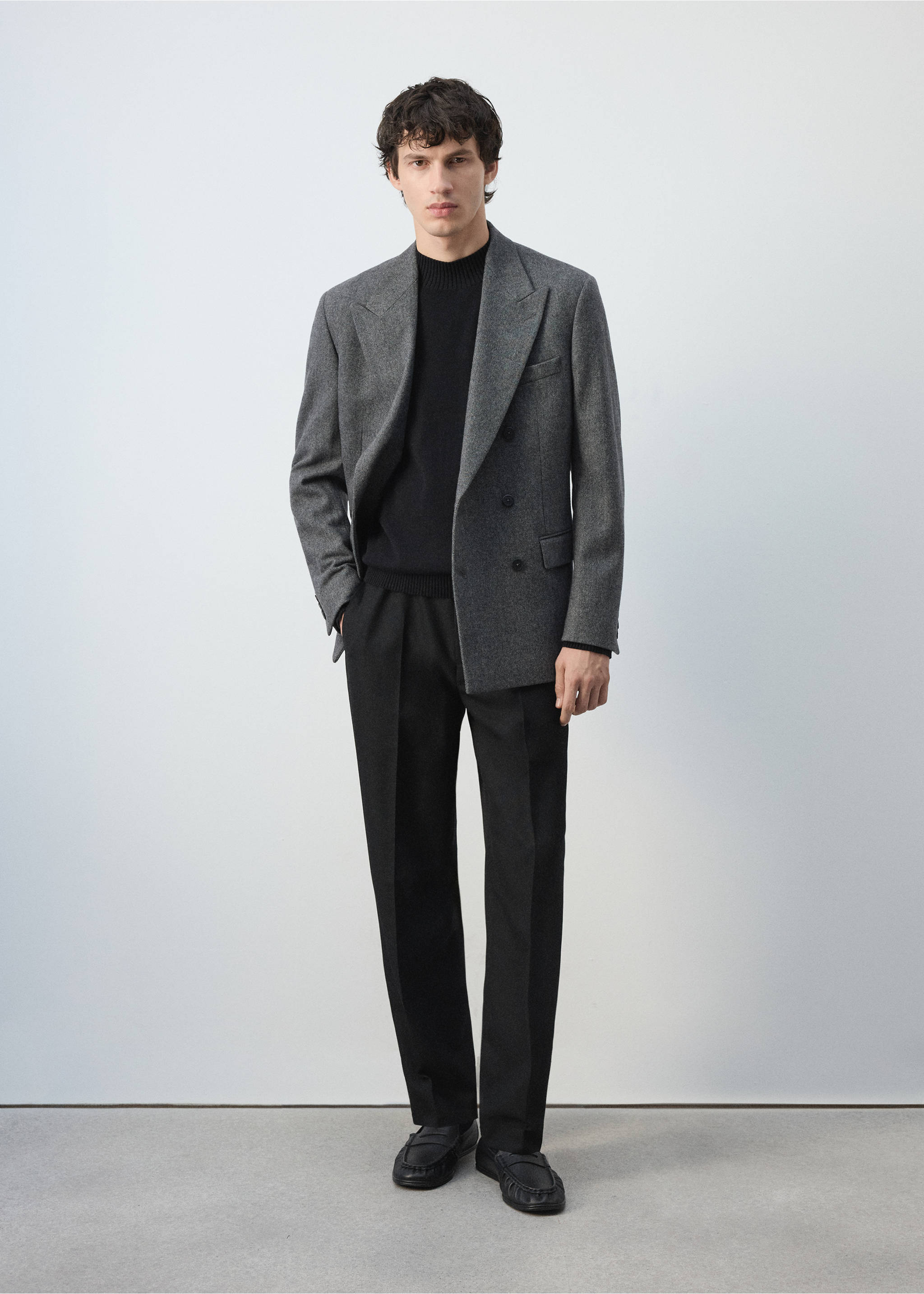 Black fine-knit jersey with a ribbed mock neckline, worn with a grey blazer and trousers., Black. Ref: 47021335-00.