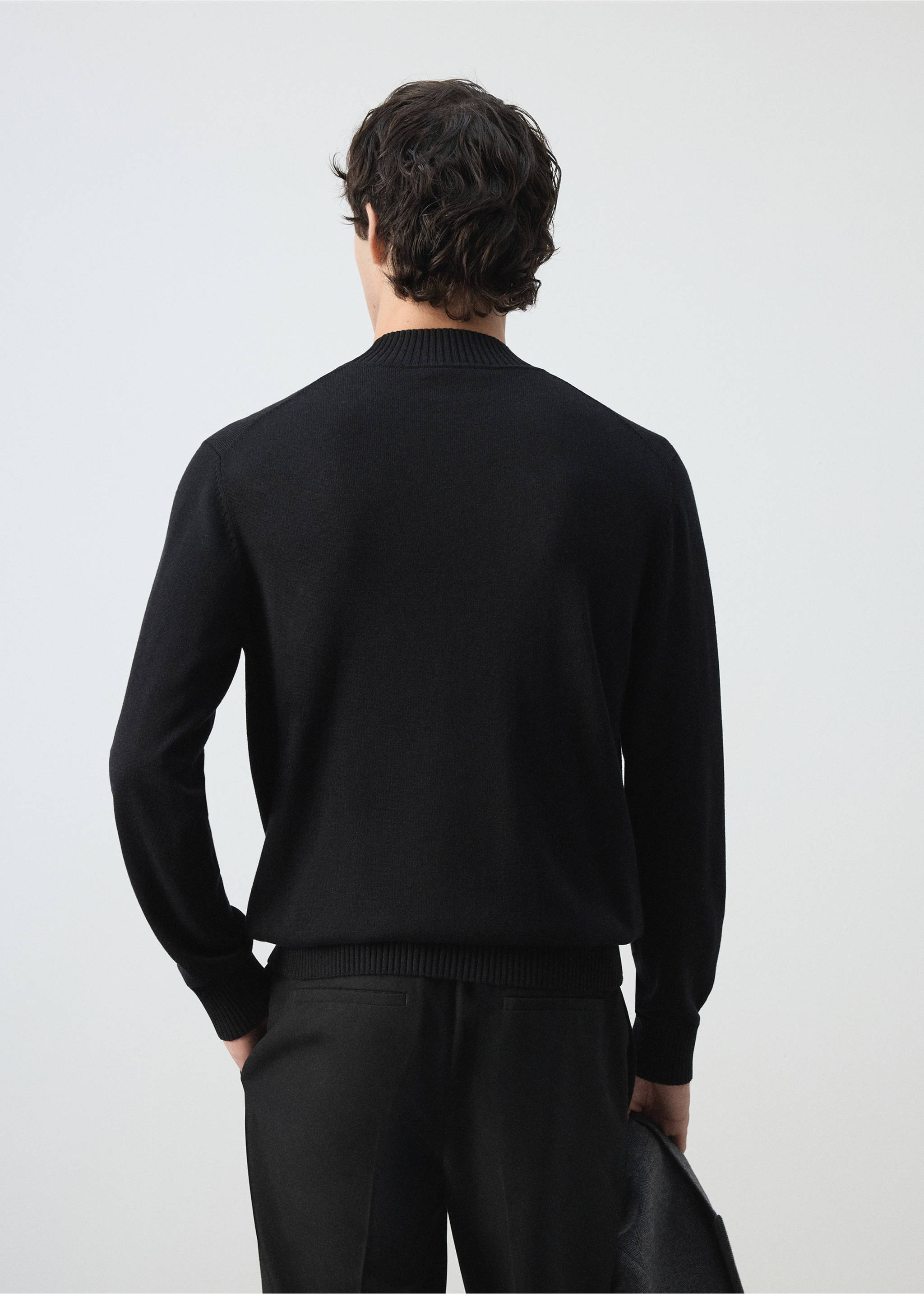 Black knit jersey shown from the back, featuring a ribbed high collar, cuffs, and hem., Black. Ref: 47021335-00.