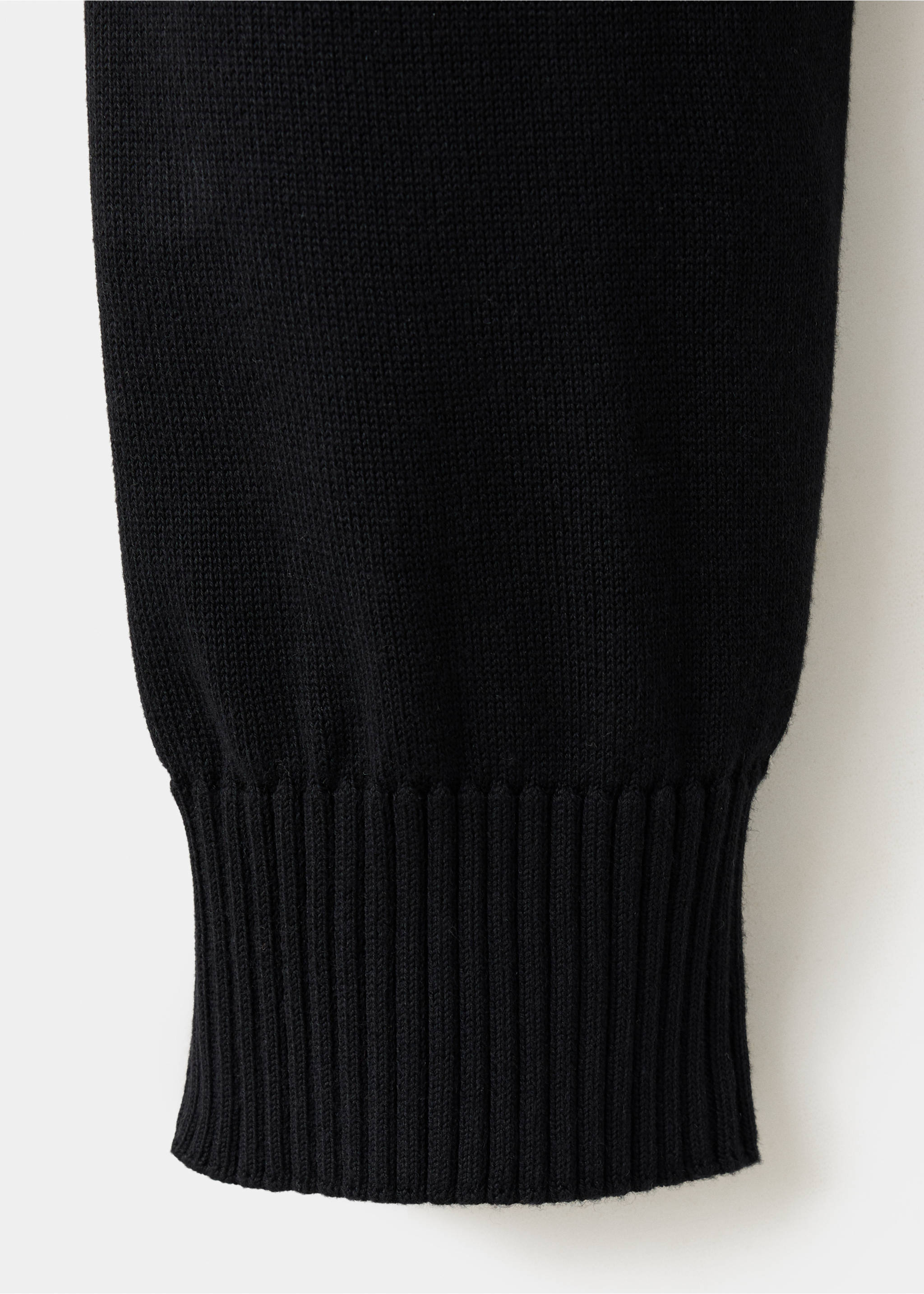Close-up of a black jersey's ribbed cuff knit detail., Black. Ref: 47021335-00.