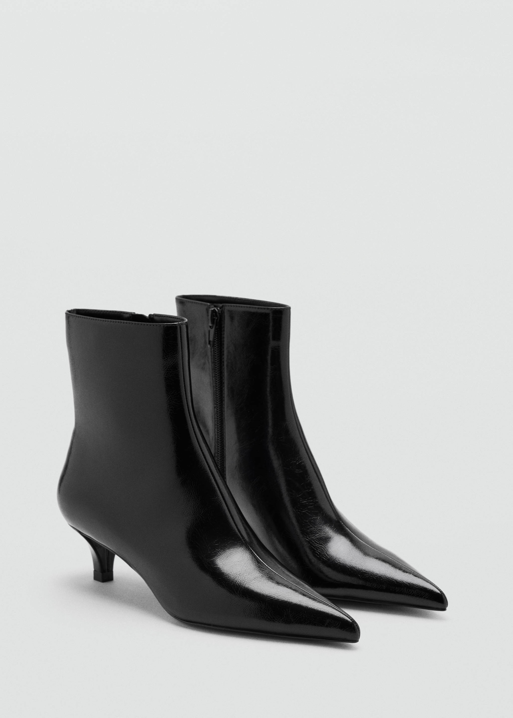 Black patent ankle boots with pointed toes and kitten heels.