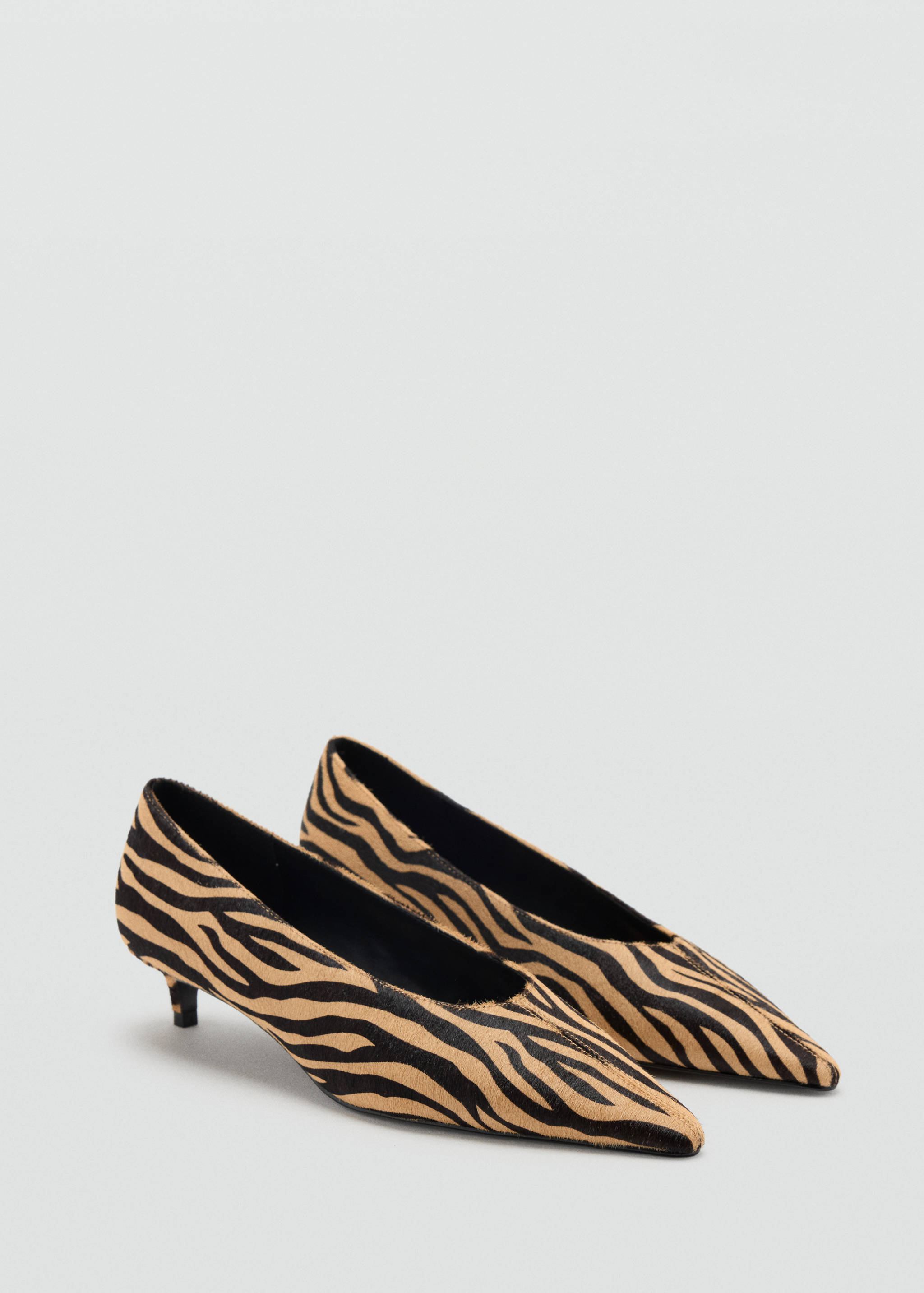 Zebra print faux-hair kitten heel shoes with a pointed toe.