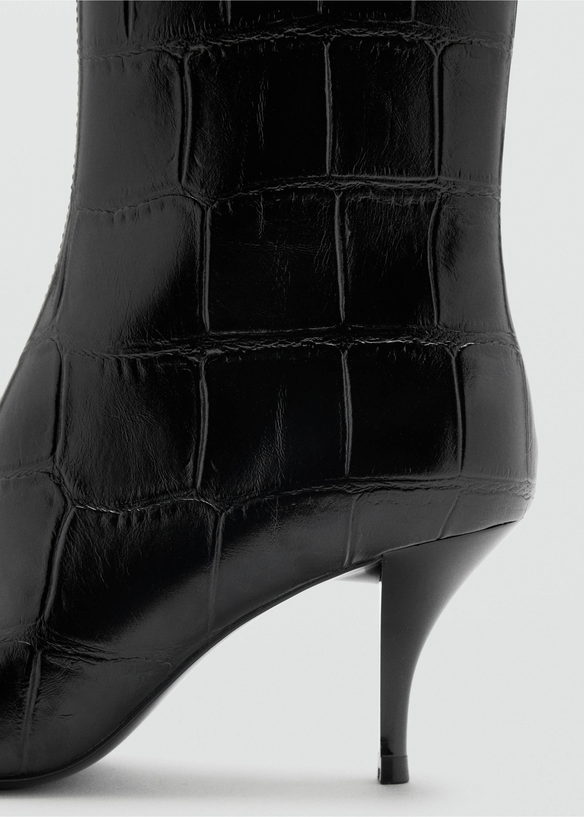 Close-up of a black crocodile-effect ankle boot with a stiletto heel., Black. Ref: 47021352-00.