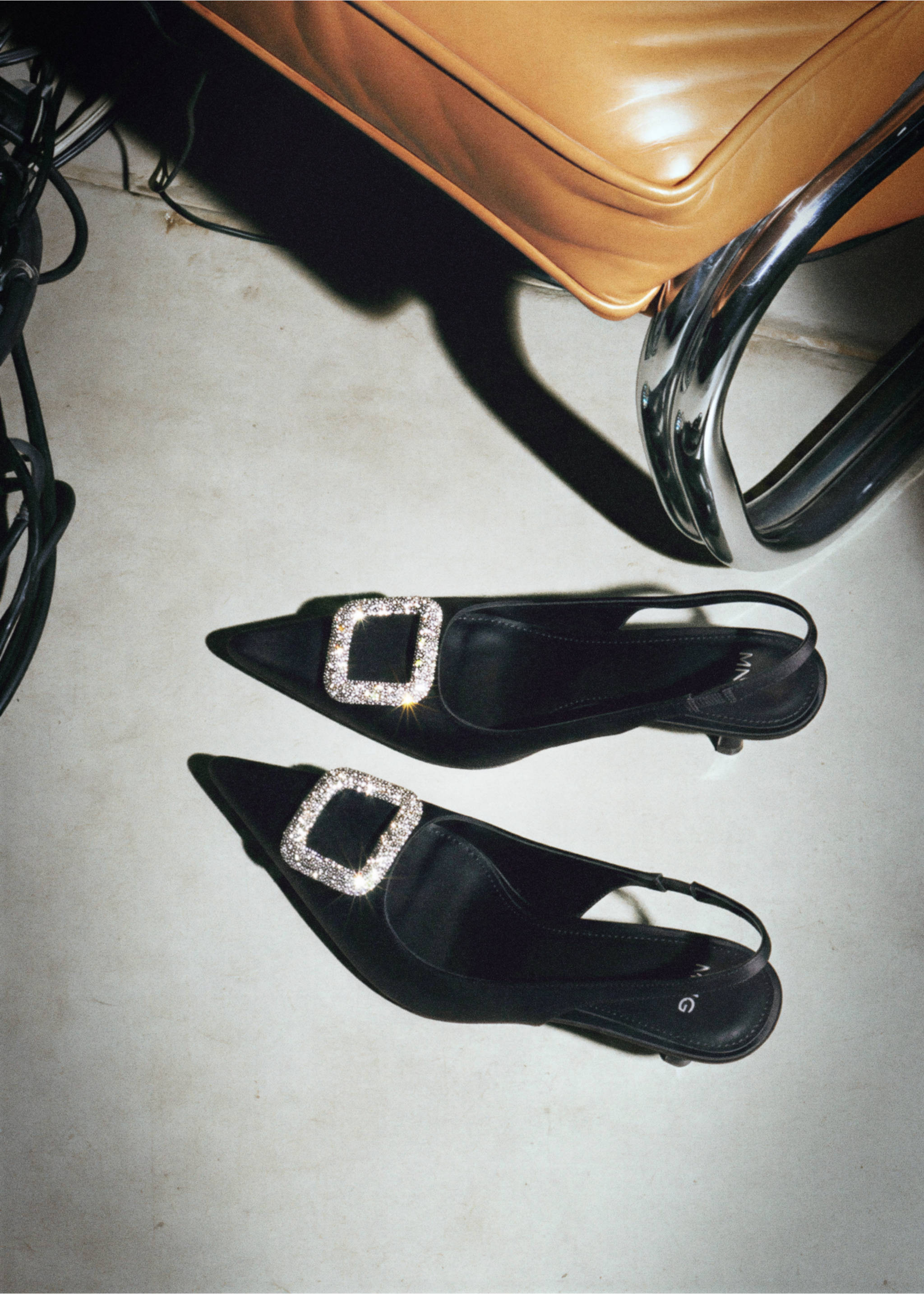 Black slingback shoes with pointed toes and rhinestone-embellished buckles., Black. Ref: 47021353-00.