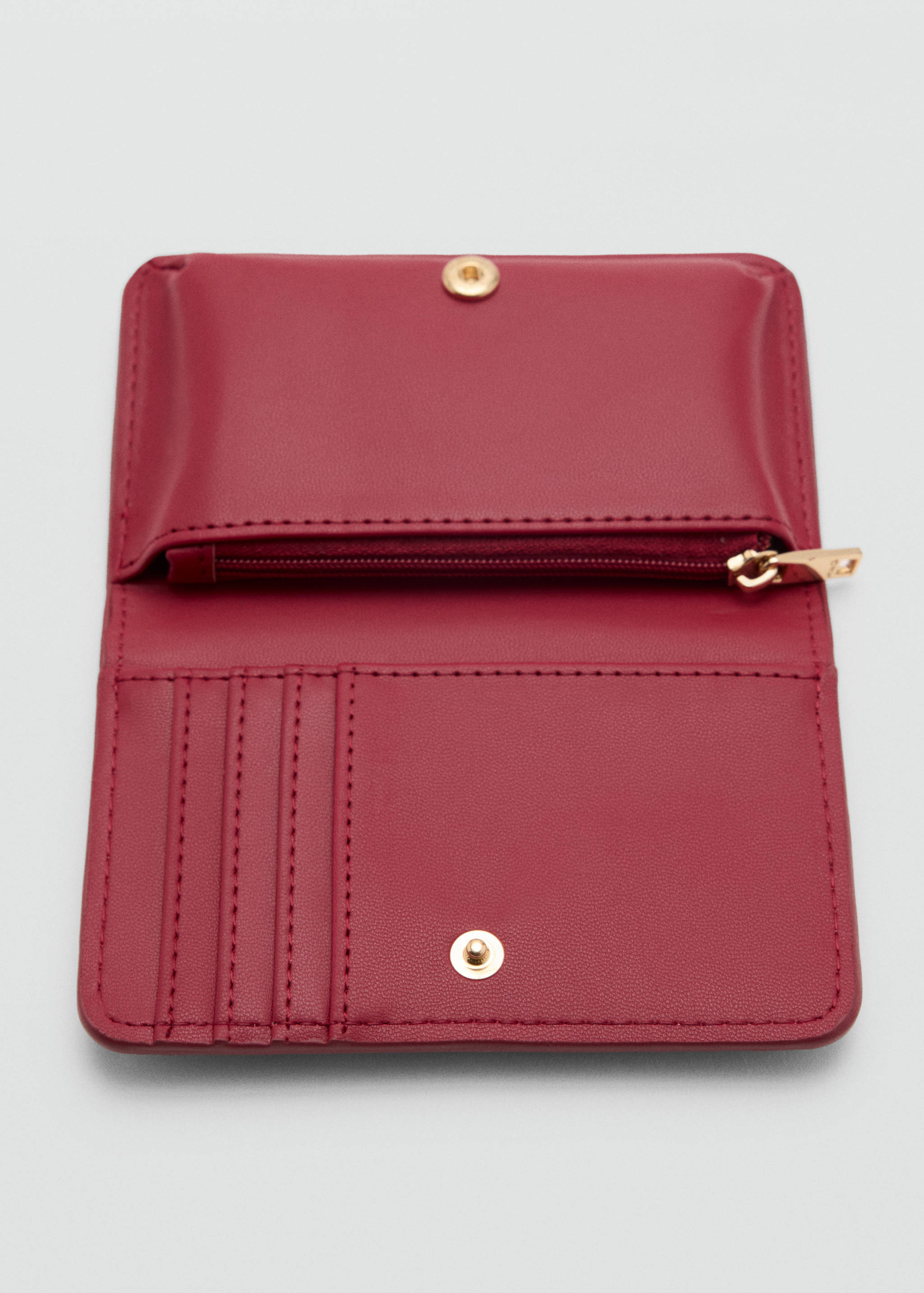 Burgundy wallet interior showing card slots and zippered compartment.