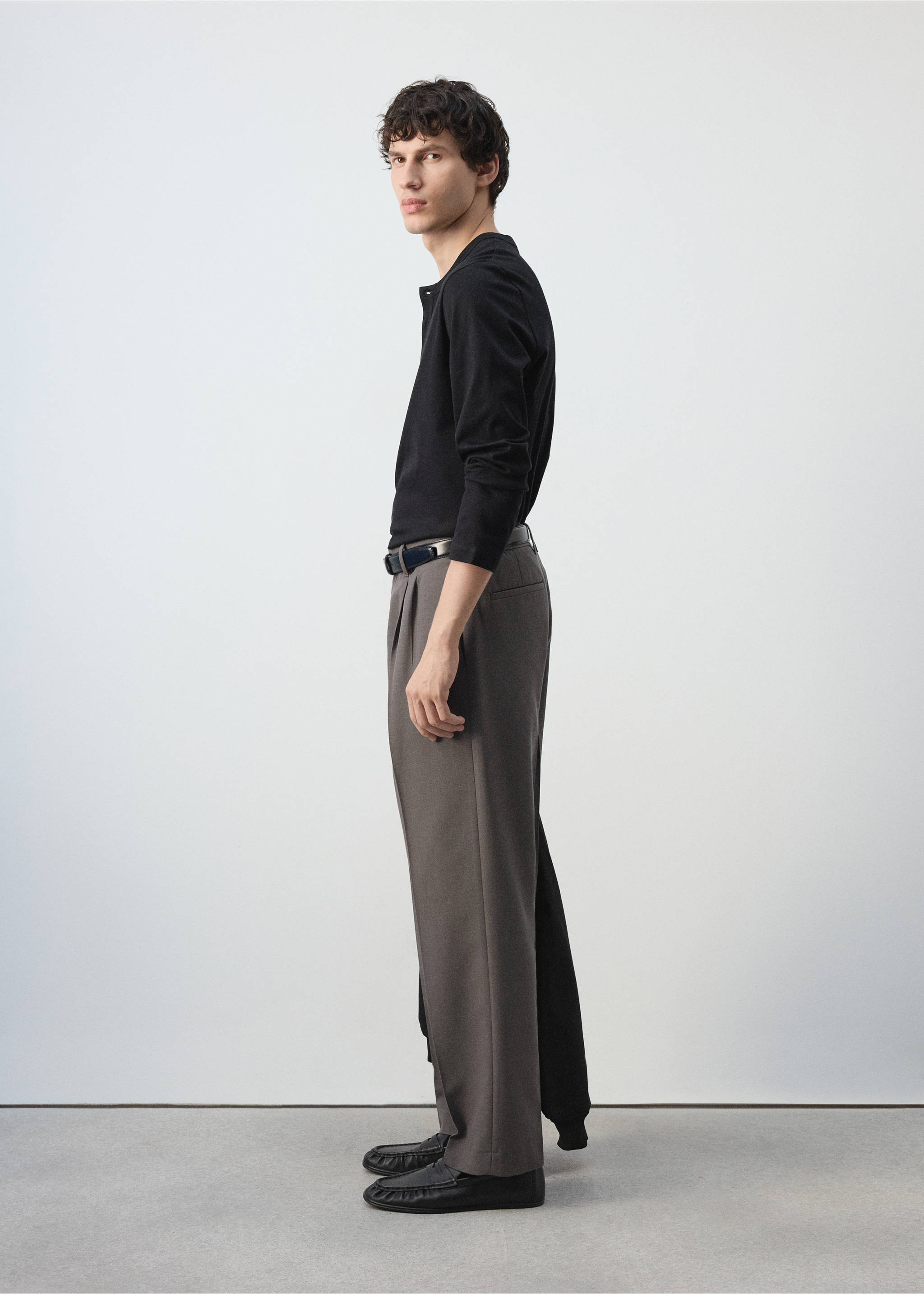 Grey pleated trousers worn with a black long-sleeved polo and shoes., Medium Brown. Ref: 47031324-00.