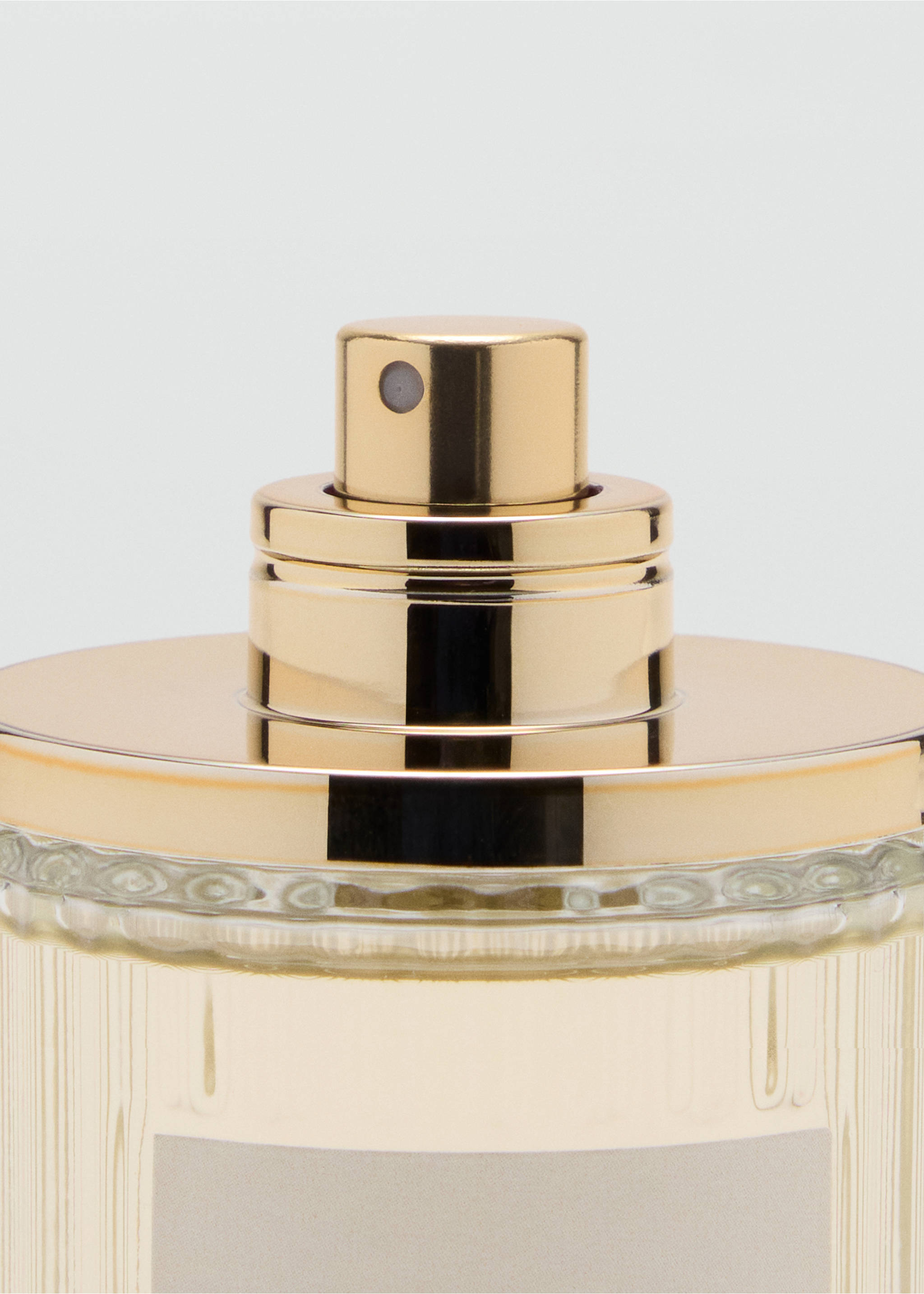 Close-up of a perfume bottle featuring a gold-coloured cap and nozzle., Mink Grey. Ref: 47031337-00.