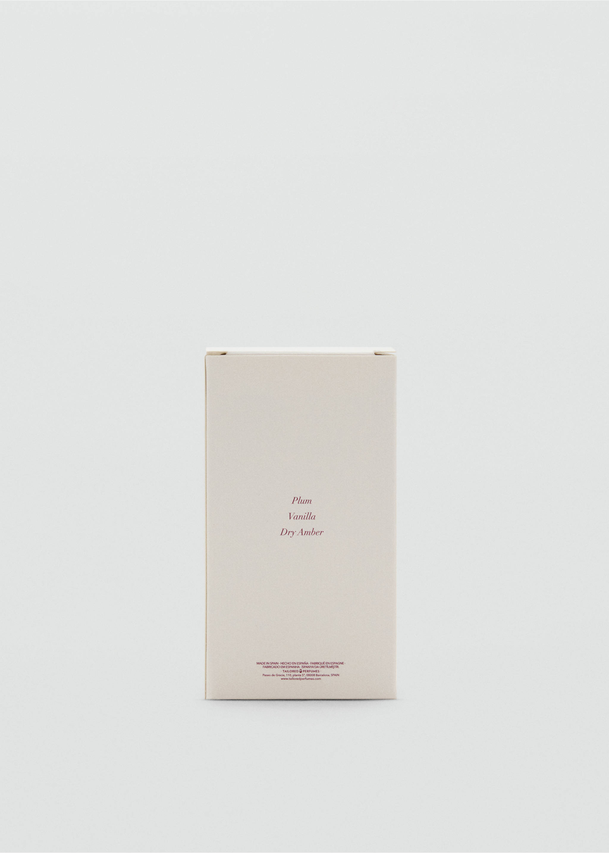 Close-up of an off-white perfume box with plum, vanilla, and dry amber text., Mink Grey. Ref: 47031337-00.