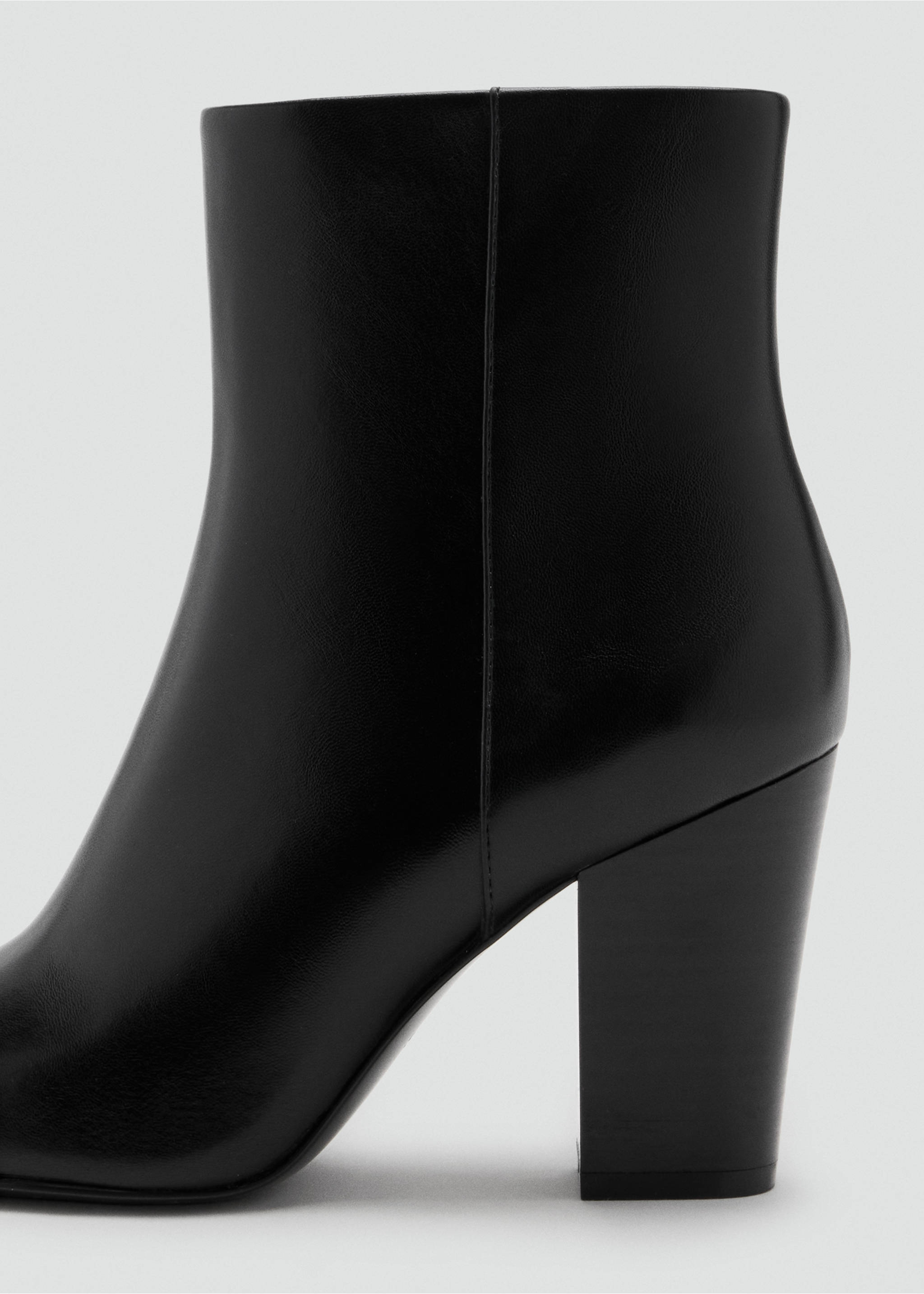 Close-up of a black leather ankle boot with a wide block heel., Black. Ref: 47031338-00.