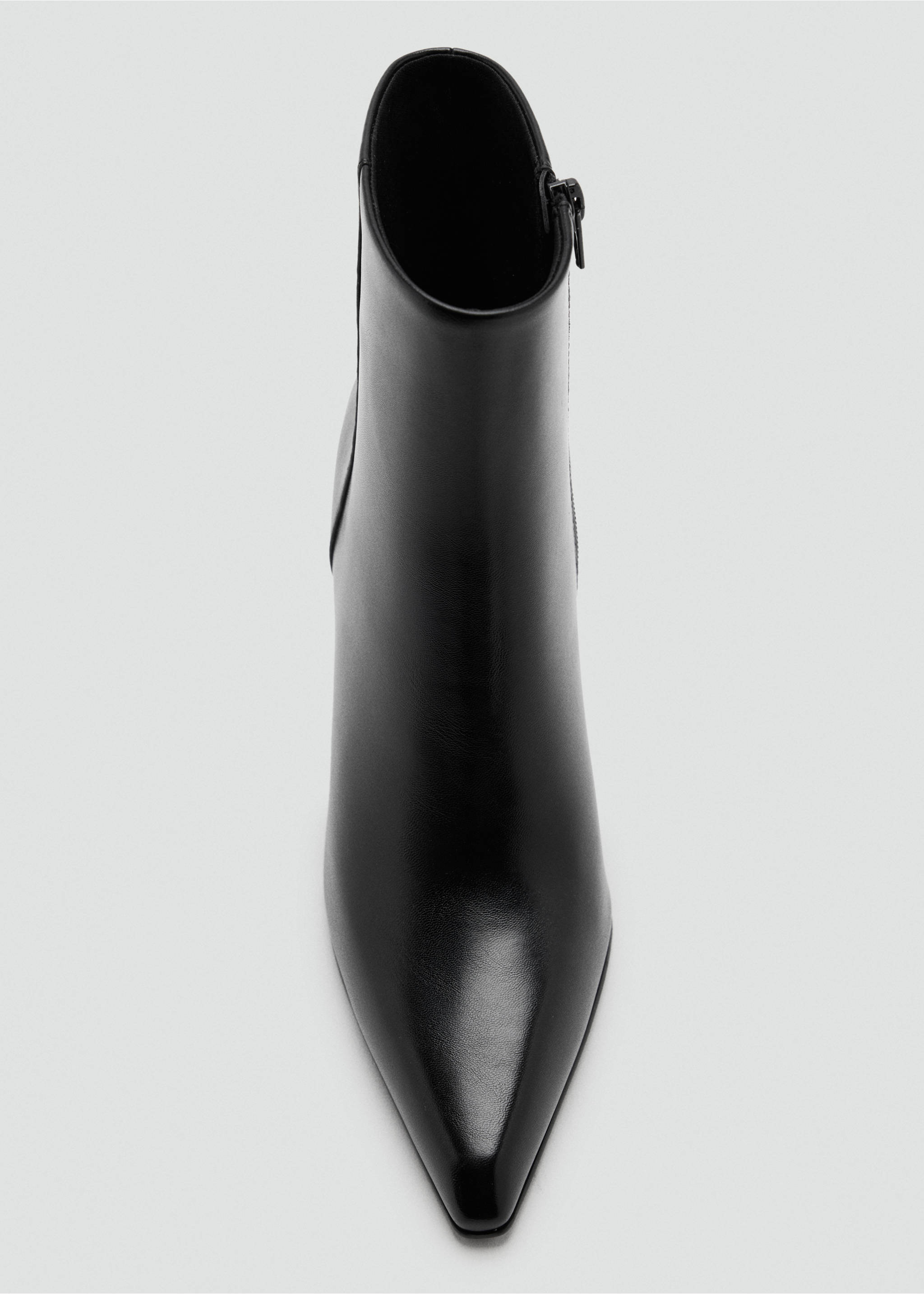 Black ankle boot with a pointed toe and side zipper in a close-up view., Black. Ref: 47031338-00.