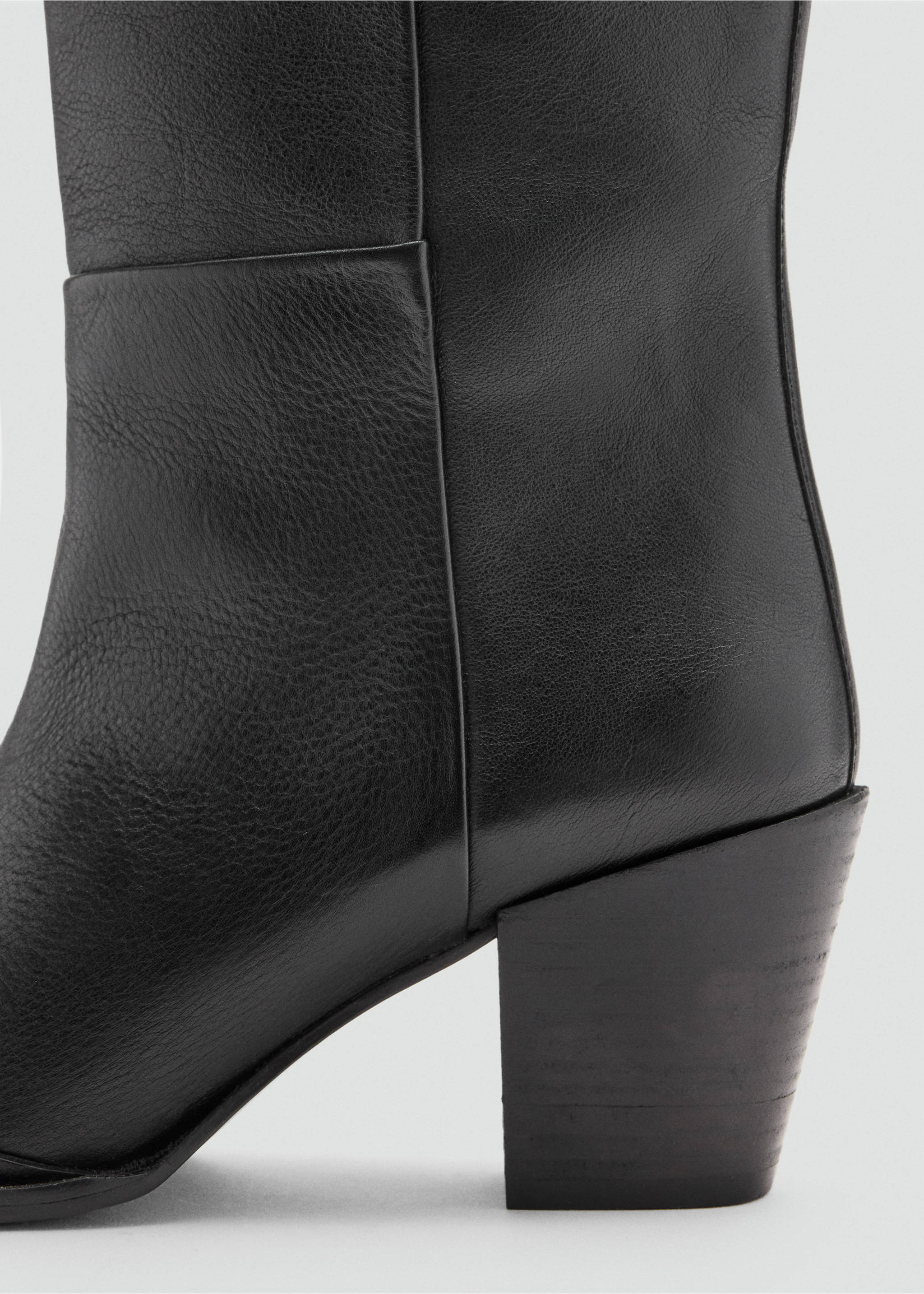 Close-up of a black leather boot showing the textured material and chunky block heel., Black. Ref: 47031341-00.