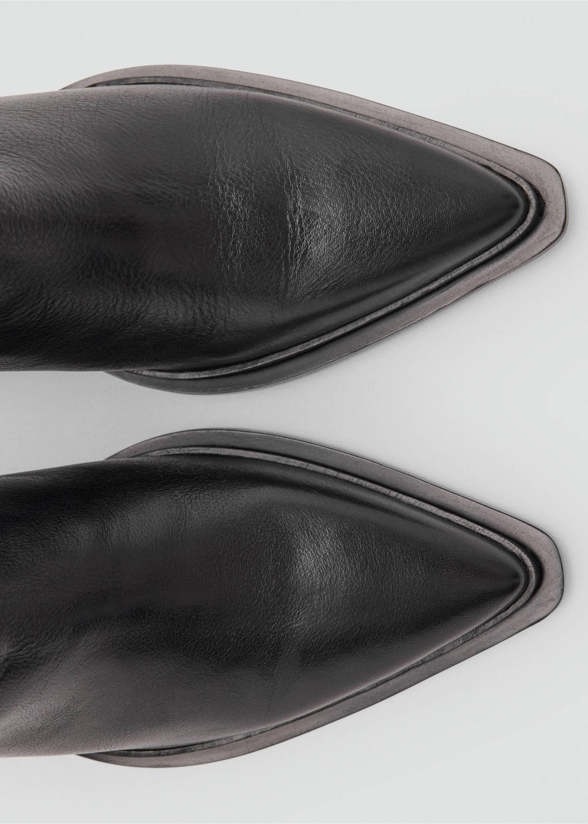 Close-up of black leather boots with a pointed toe., Black. Ref: 47031341-00.