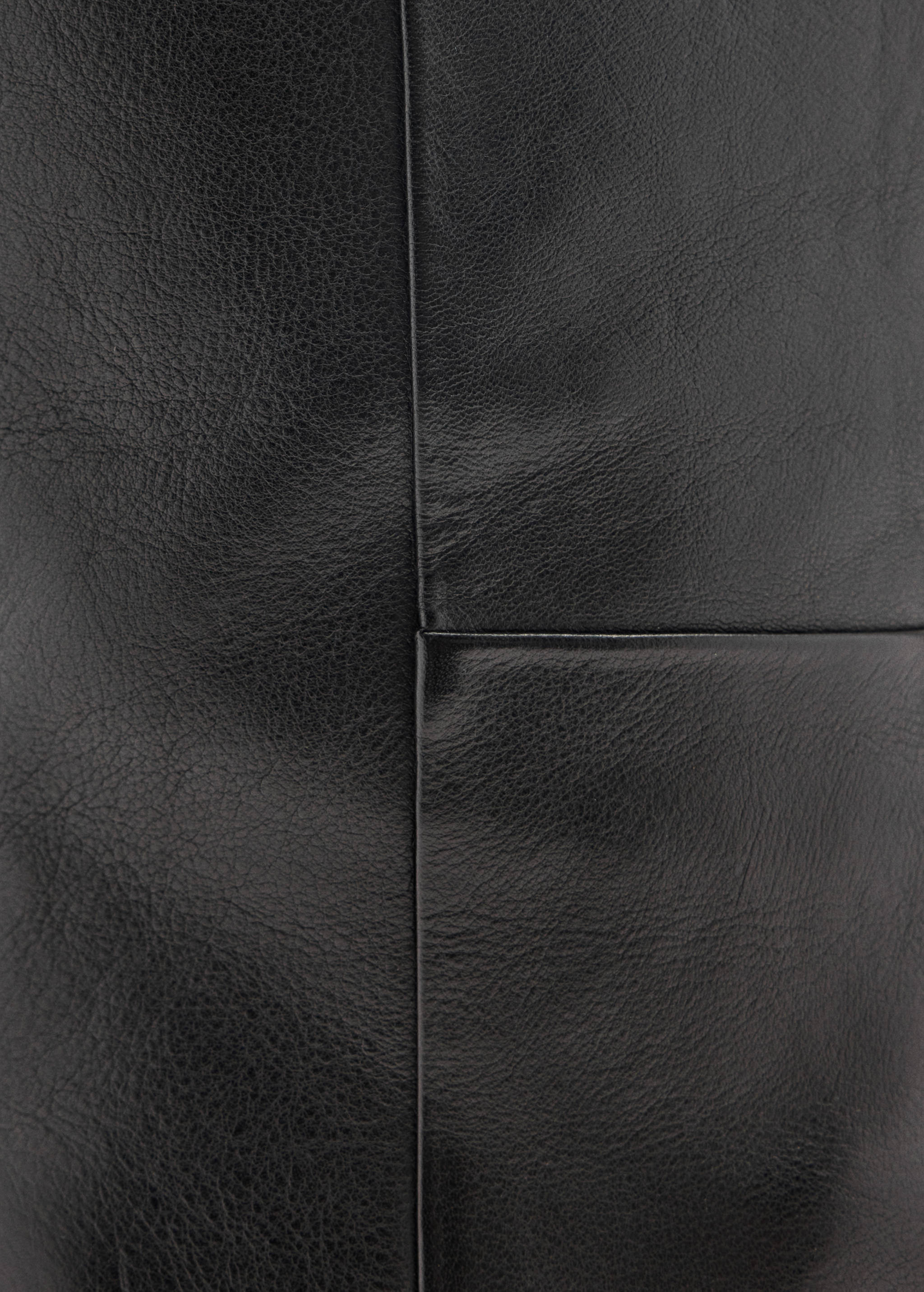 Close-up of a black boot with visible panel seams.