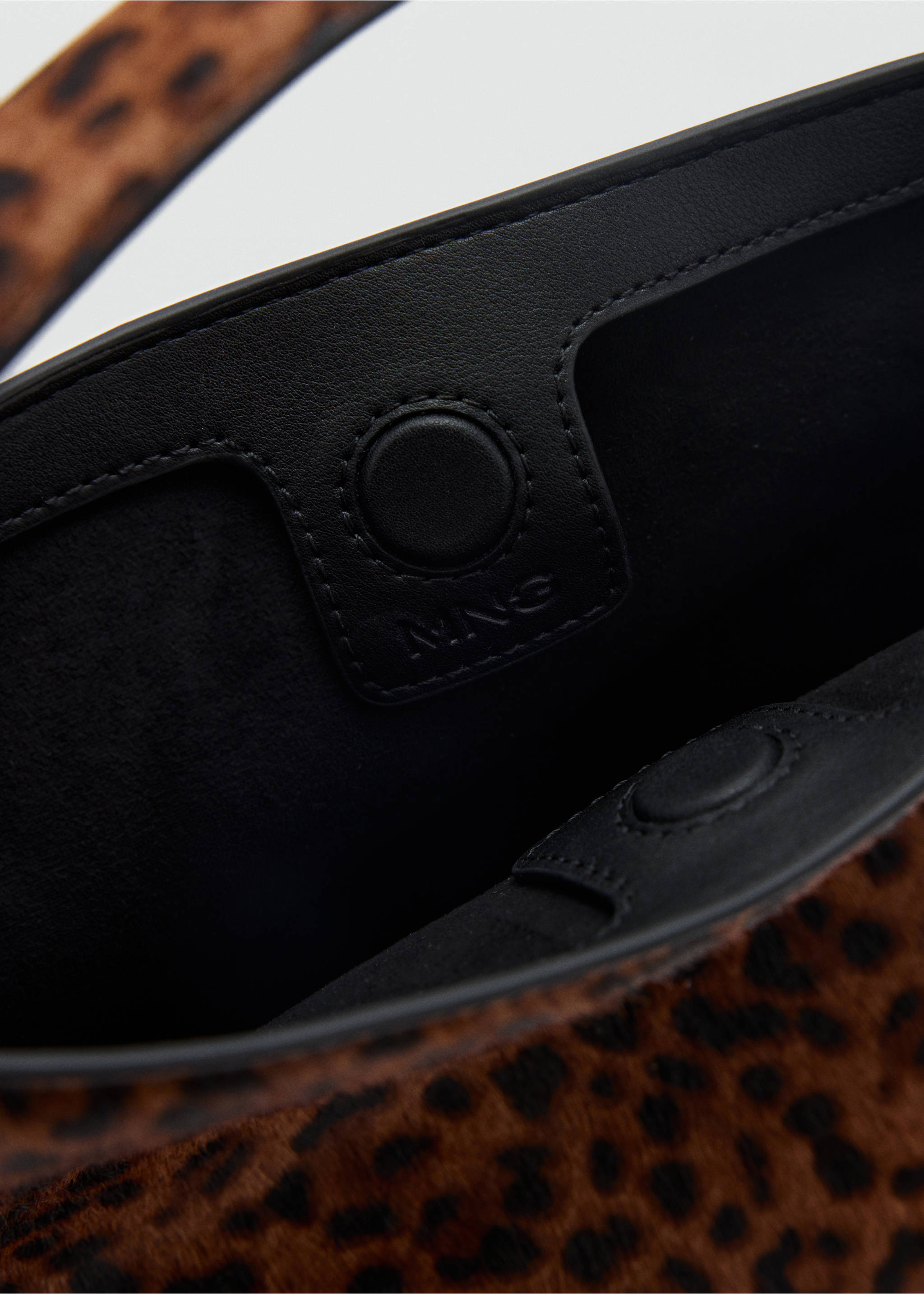 Leopard print faux-fur bucket bag interior detail with black lining., Tobacco Brown. Ref: 47031347-00.