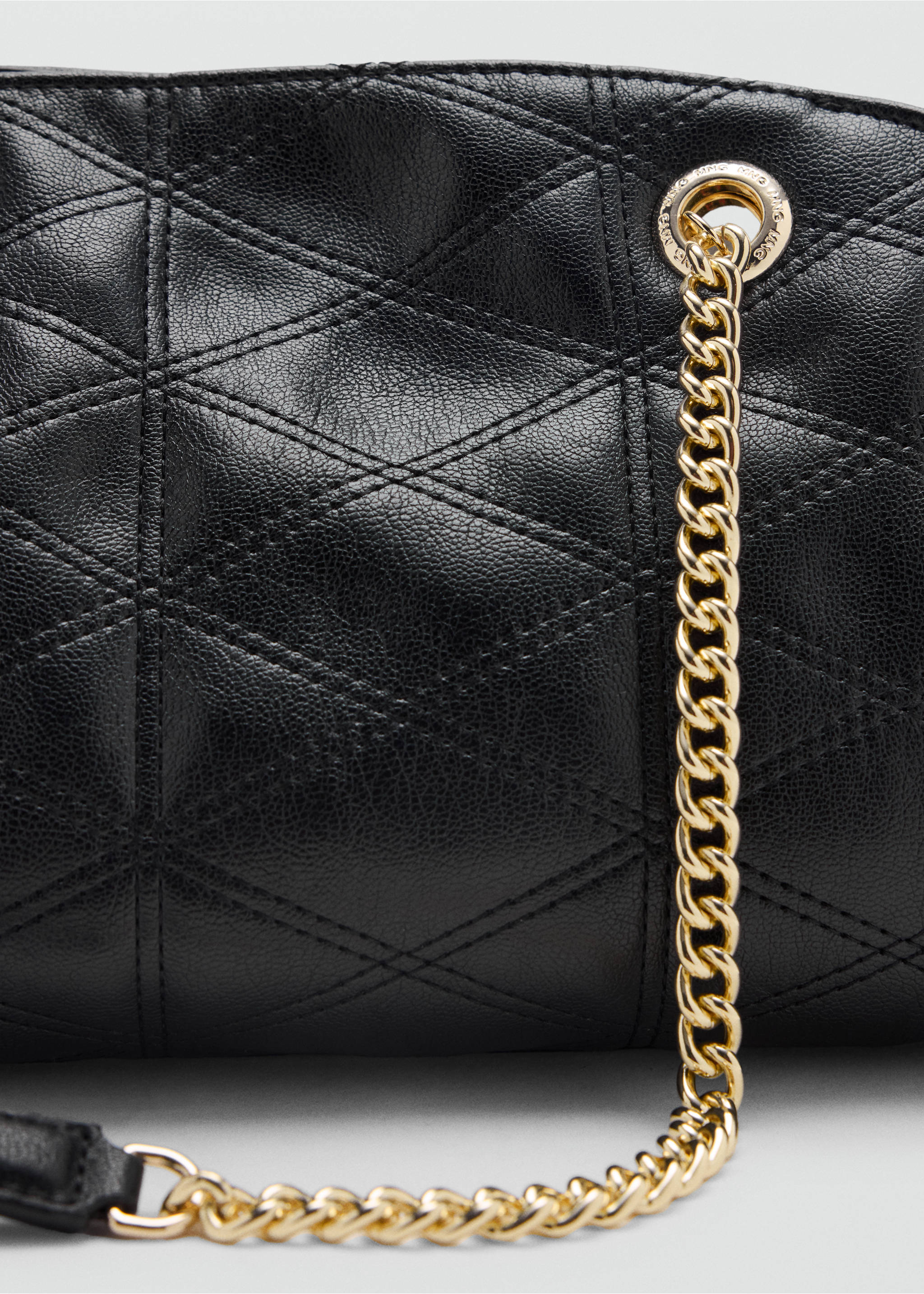 Close-up of a black quilted shoulder bag with a gold-tone chain strap., Black. Ref: 47031350-00.
