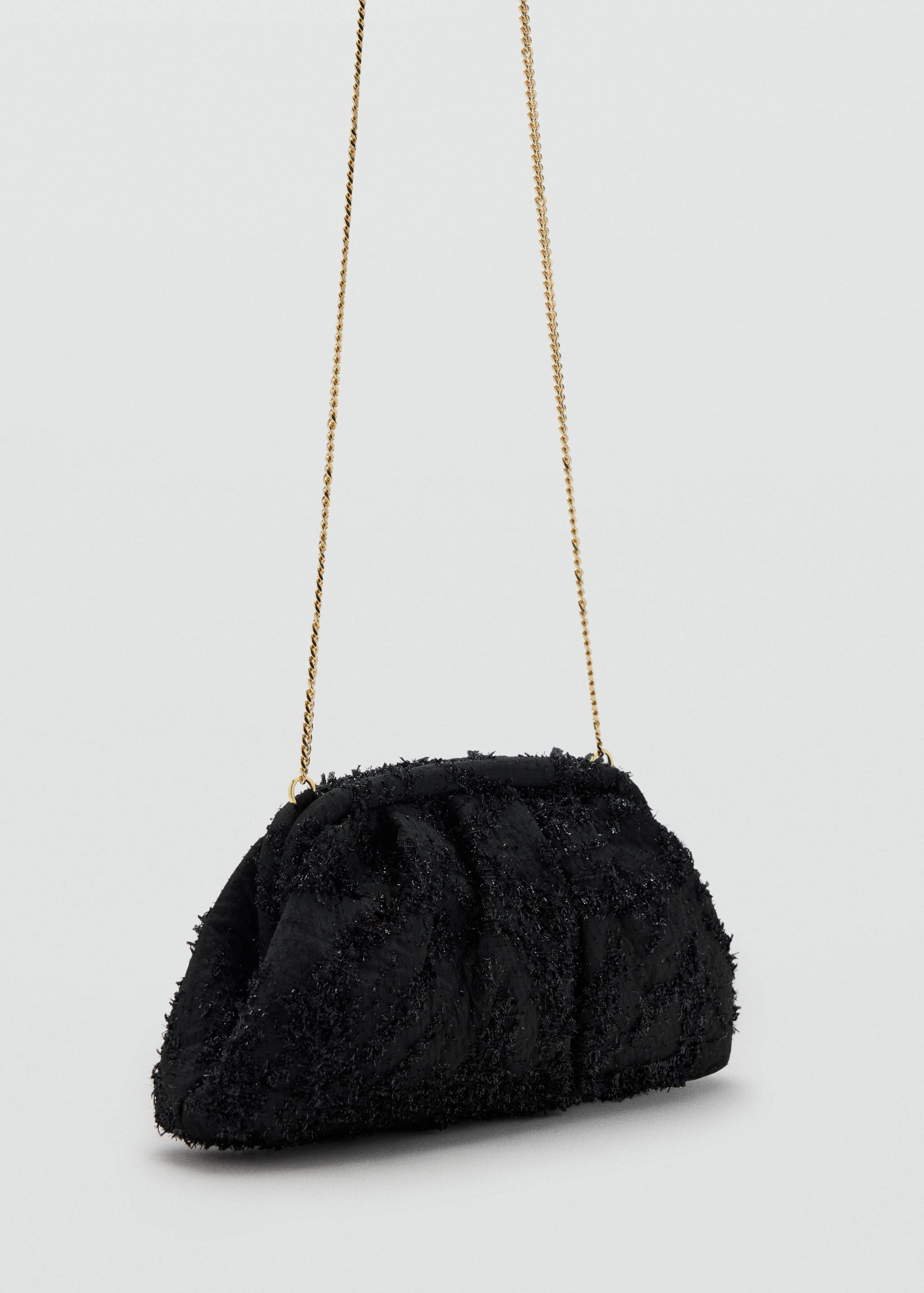 Black textured pouch handbag with a gold chain strap.