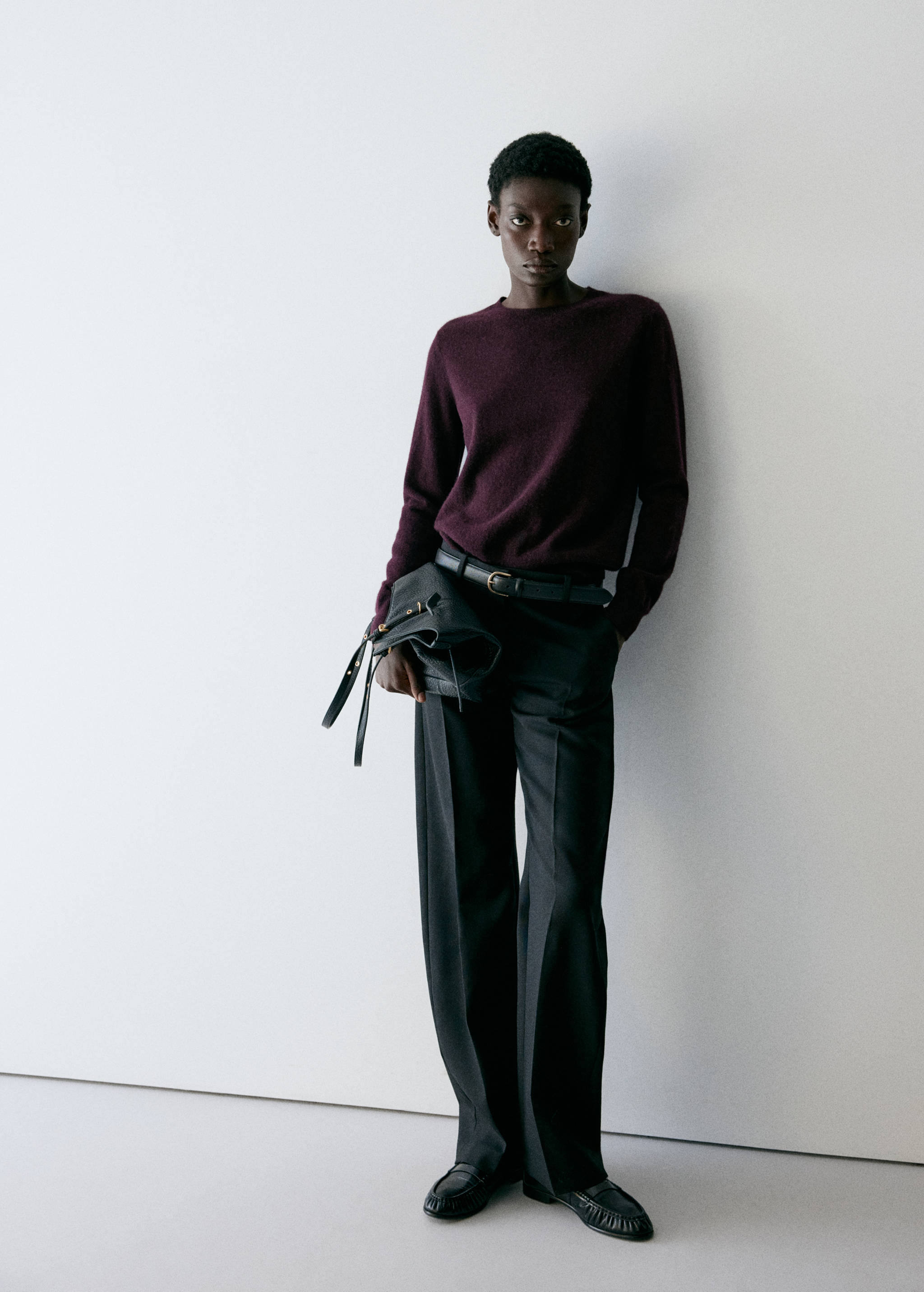 Burgundy crew neck jersey worn with dark grey trousers and loafers.