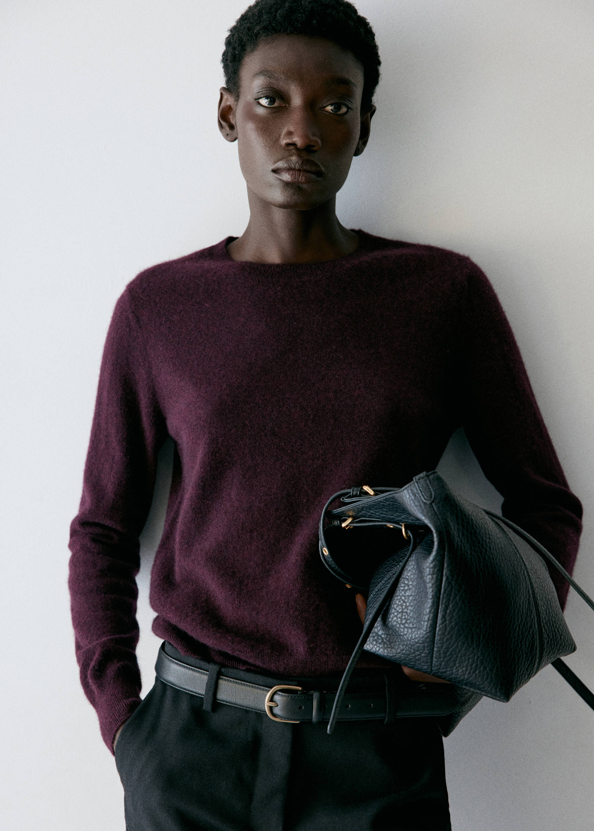 Plum round-neck knitted jumper in a soft, textured finish.
