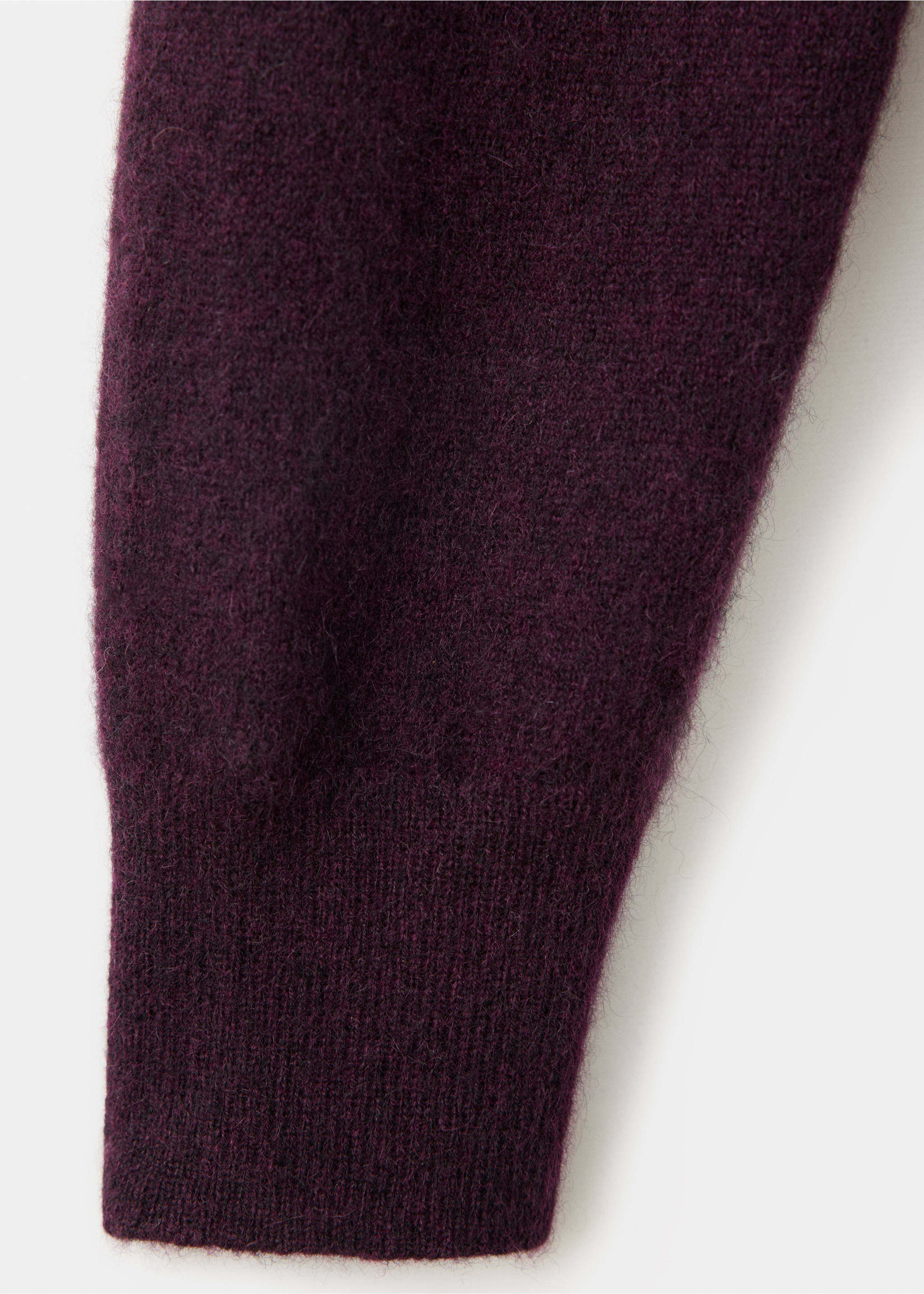 Close-up of the dark purple knit sweater fabric and ribbed cuff., Wine. Ref: 47031363-00.
