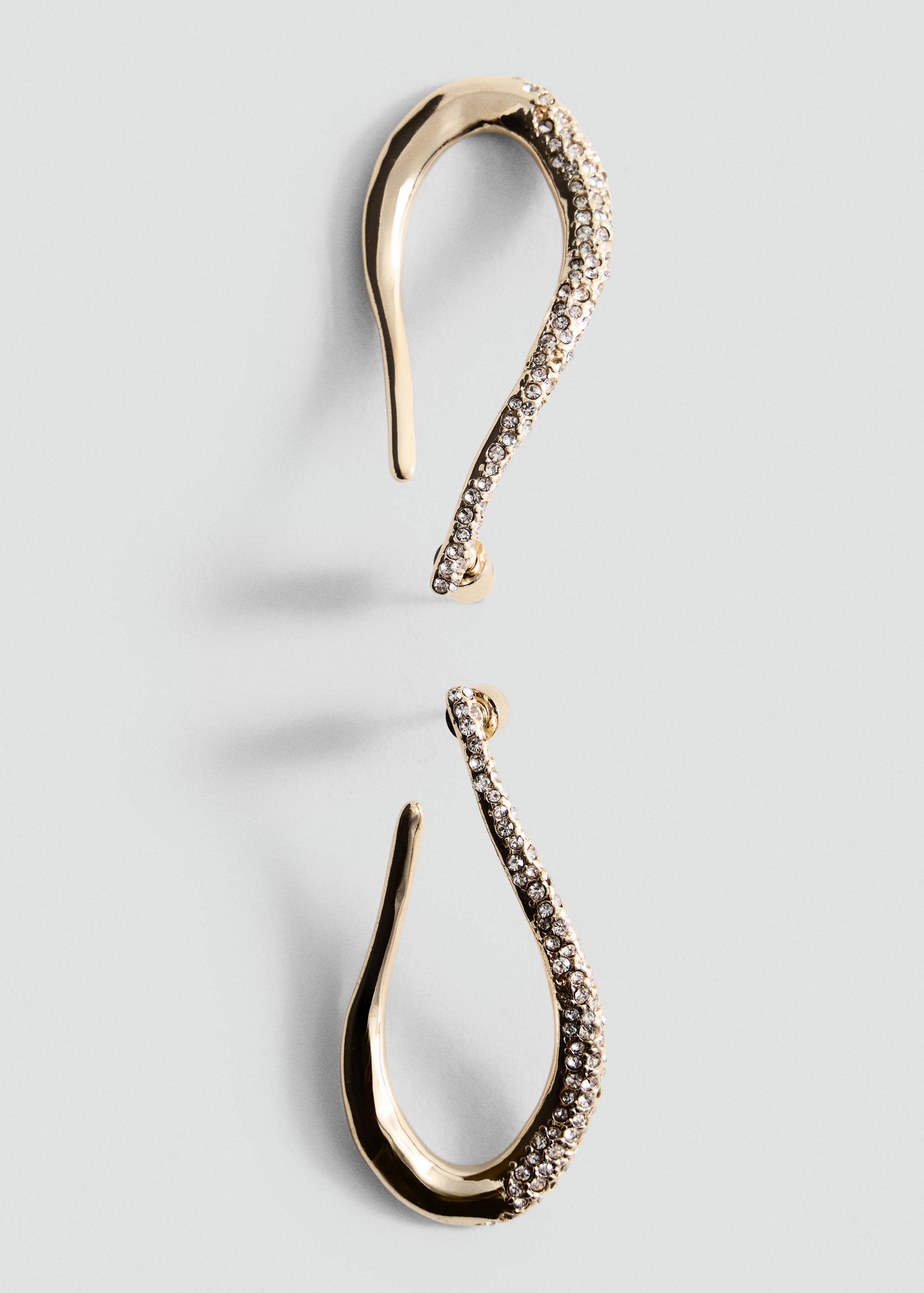 Gold-toned asymmetric earrings featuring pavé rhinestones.